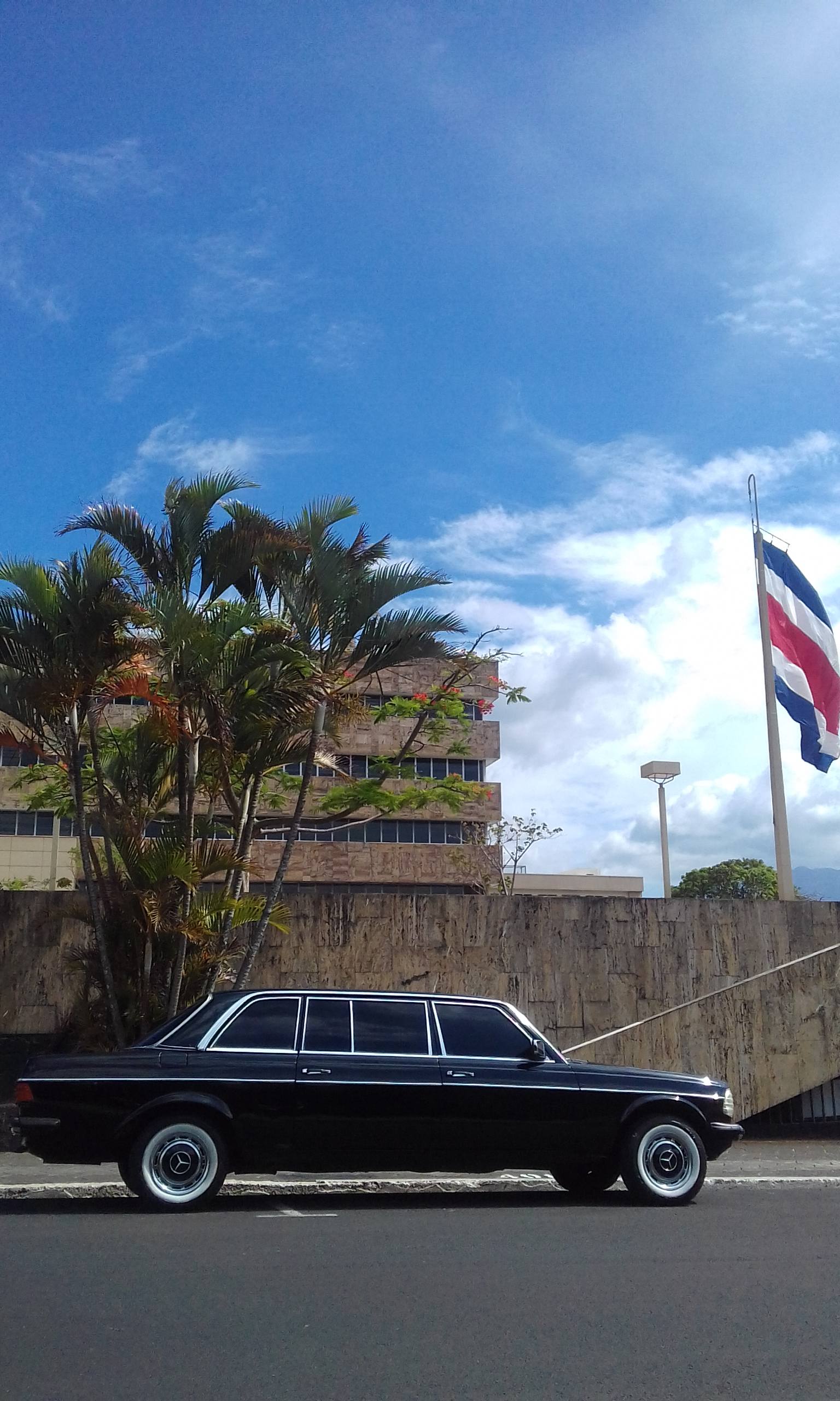 COSTA RICA BUILDING WITH A FLAG AND LIMOUSINE MERCEDES 300D