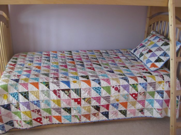 half-square-triangle-quilt-on-bed-700x525