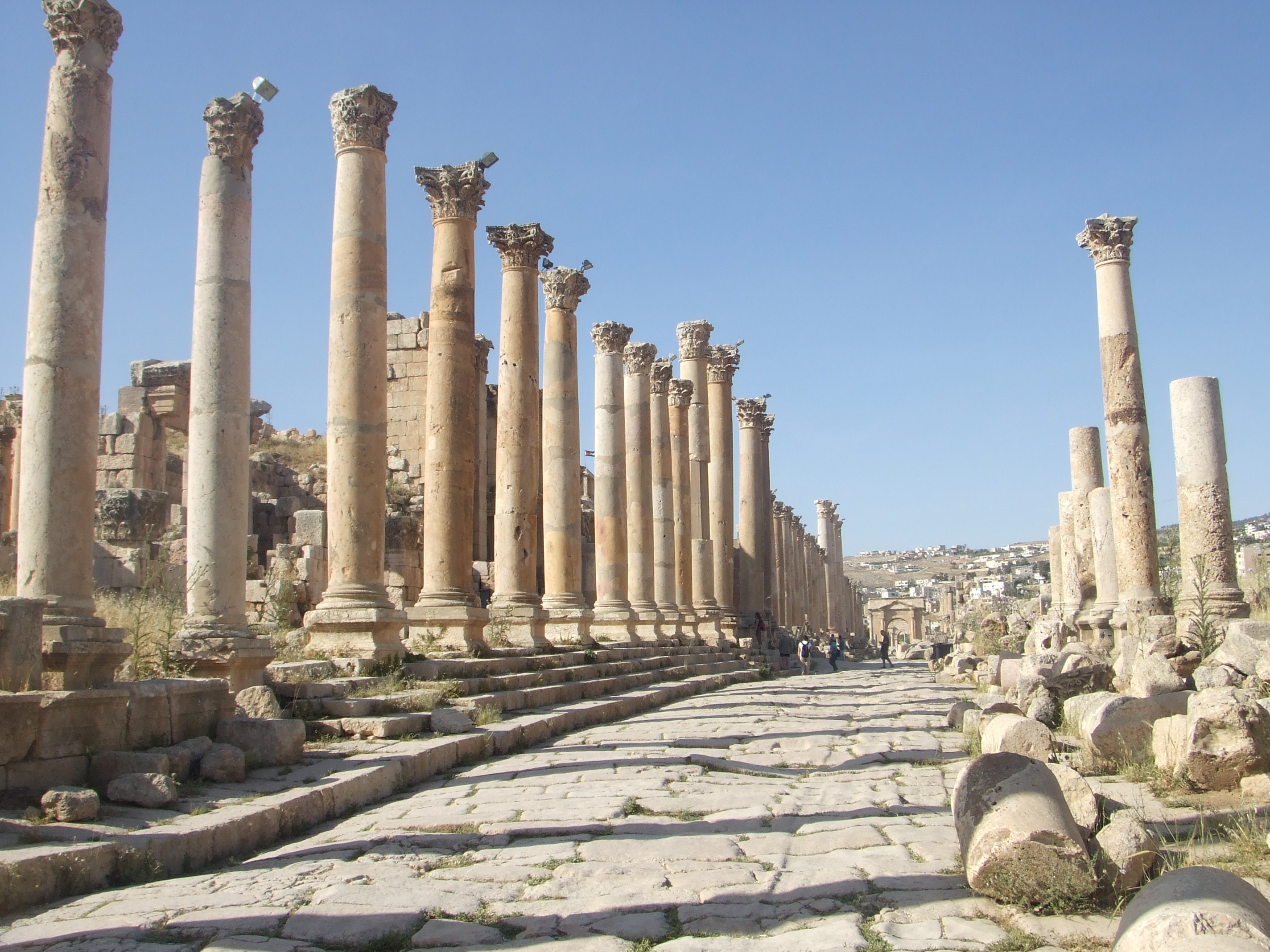 Colonnaded Street, Jerash The Greco-Roman city of Jerash (ancient Gerasa) is one of the most important and best preserved Classical sites in the Near East. The city's major buildings and monuments are in good condition and the huge extent of the site is impressive. Restoration and reconstruction of important elements has continued throughout the 20th century and today the ancient ruined city sits immediately alongside the thriving modern town of Jerash. The sprawling site is dominated by it's more significant remains, which include the seemingly numerous columns of the main colonnaded street and oval forum, along with two fine amphitheatres, several temples and imposing triumphal arches. For more information see below:- en.wikipedia.org/wiki/Jerash