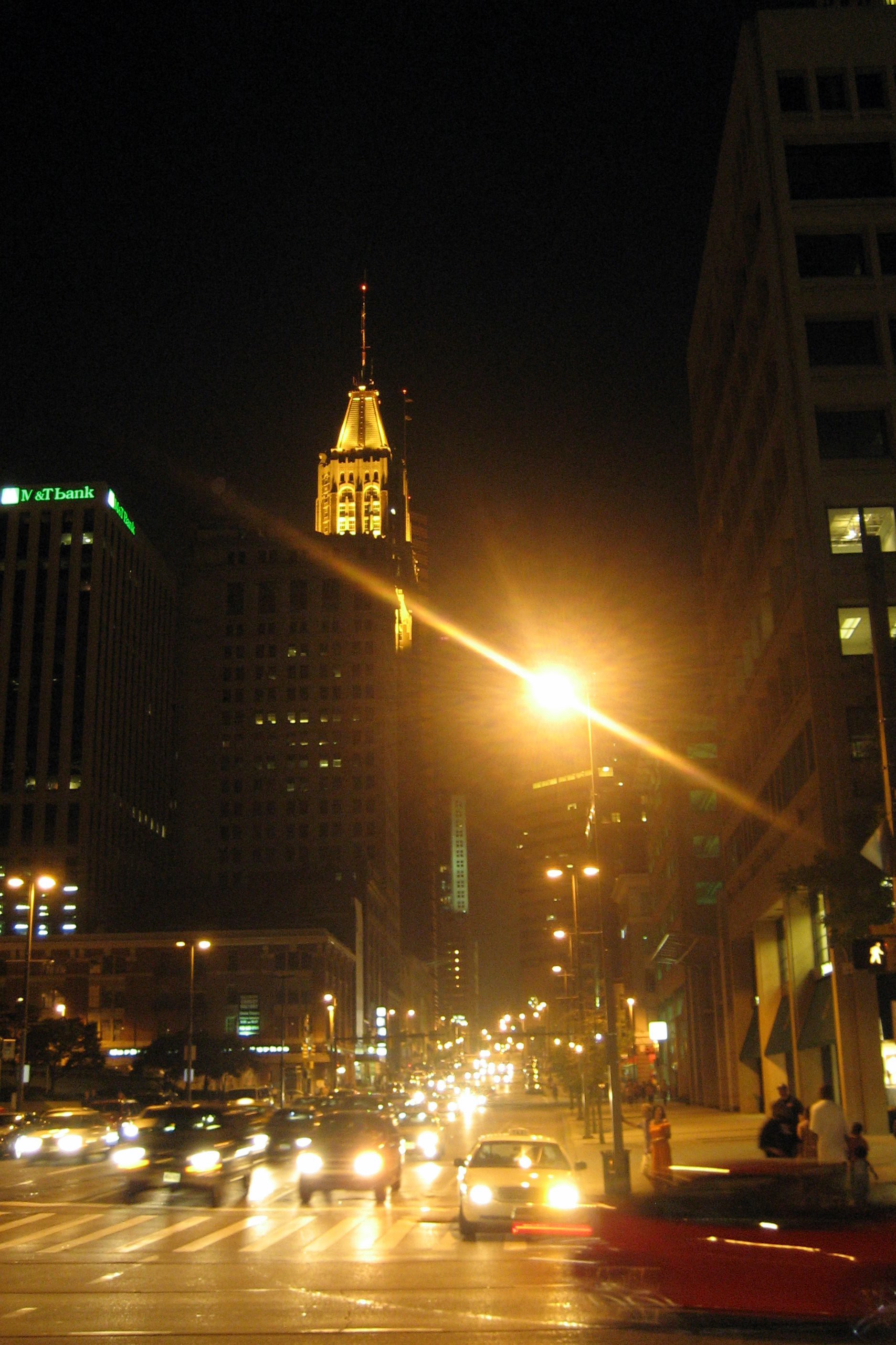 Baltimore: Bank of America Building The Bank of America Building, originally the Baltimore Trust Building, at 10 Light Street was built in 1929 by Taylor & Fisher and Smith & May. The 505-foot Art Deco tower was Baltimore's tallest until the Legg Mason Building was completed in 1973. The building's exterior is decorated with bird and lion carvings, Maya-style human faces and is capped with a copper and gold roof. The ornate, two-story main banking lobby is highly decorated with mosaic floors designed by Hildreth Meiere, and historic murals by McGill Mackall on historic themes: the Baltimore fire of 1904, and the writing of the National Anthem at the Battle of Baltimore during the War of 1812. Shortly after the Baltimore Trust Company moved into the building in 1929, the bank went into bankruptcy in 1933, followed by receivership in 1935. The New Deal's Public Works Administration occupied the building until it was bought by the Maryland National Bank in 1961, which was purchased by NationsBank in 1993. NationsBank merged with Bank of America in 1997.