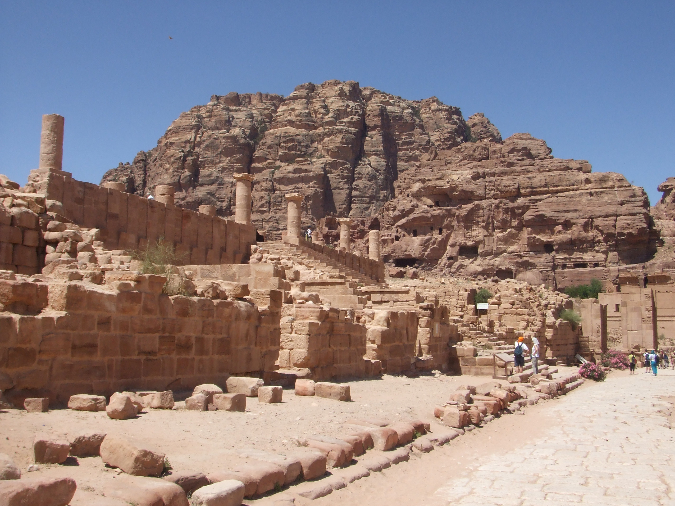 Ruins of the Great Temple, Petra Petra's 'Great Temple' is one of the site's most mysterious buildings. Situated in the colonnaded street it was the most significant building in the urban area of the city, where buildings were constructed from blocks, rather than carved into the rock like the more famous tombs were, and therefore far less well preserved. The temple itself consists of a rectangular building beyond a large colonnaded forecourt raised on a terrace (many of the column capitals had unusual elephant head designs). At the rear are remains of an apparently more secular complex including a small semi-circular auditorium, presumably the seat of local government.