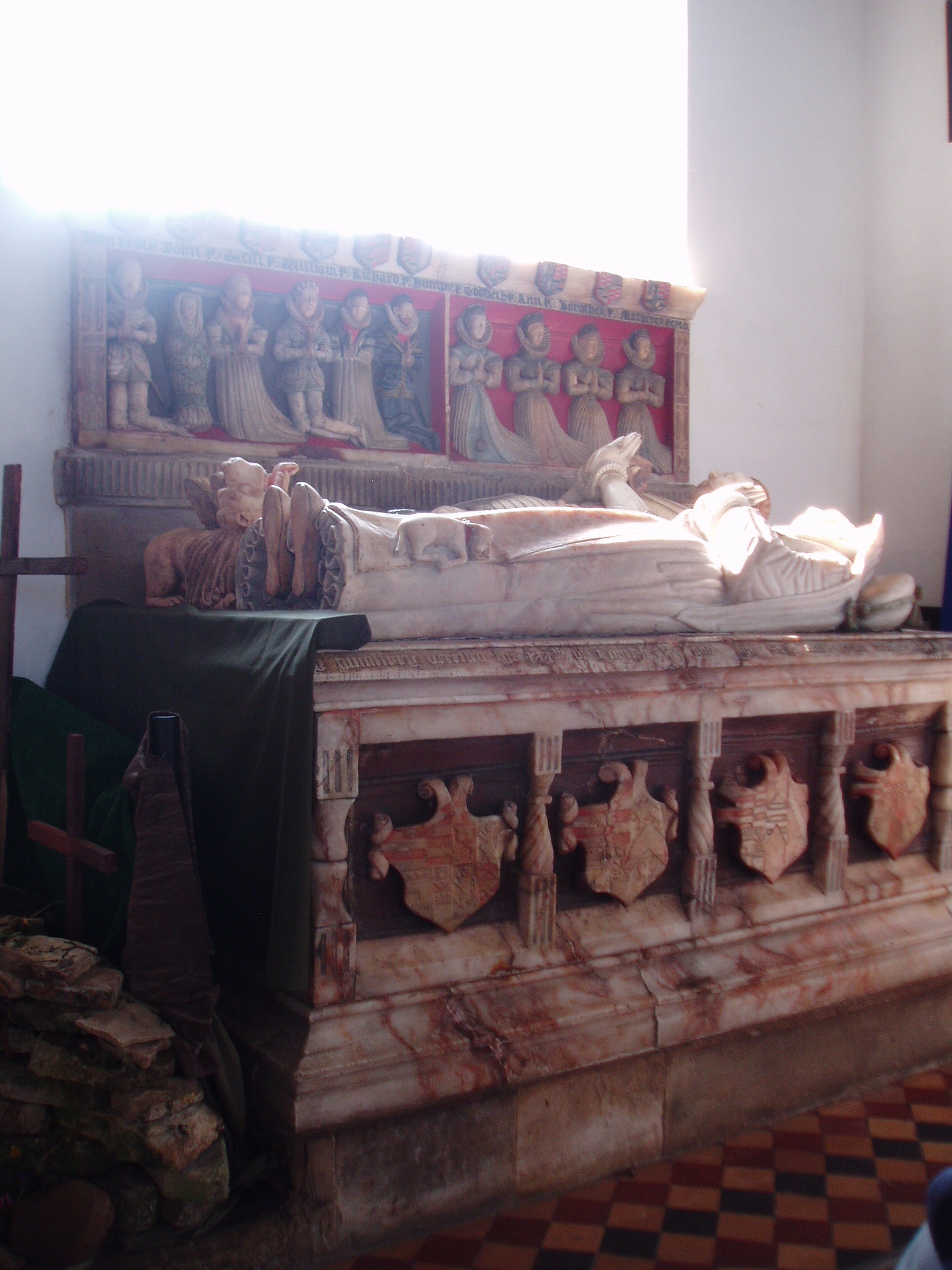 Humphrey Peyto Tomb Alabaster tomb of Humphrey Peyto and wife c1585 (and somewhat overpowered by strong lighting here!), in the south west corner of Chesterton church. St Giles is a long low building mostly dating from the 14th and 15th centuries. It's interior has a tunnel-like effect, there being little structural difference between nave and chancel, all one long chamber without aisles, separated only by a modest screen. It's most important features are the group of monuments at the west end of the nave, all to members of the Peyto family, builders of the renowned windmill nearby, and former occupants of the now vanished mansion that stood immediately north of the church (built 1650-60, demolished 1802; only an impressive gateway arch remains).