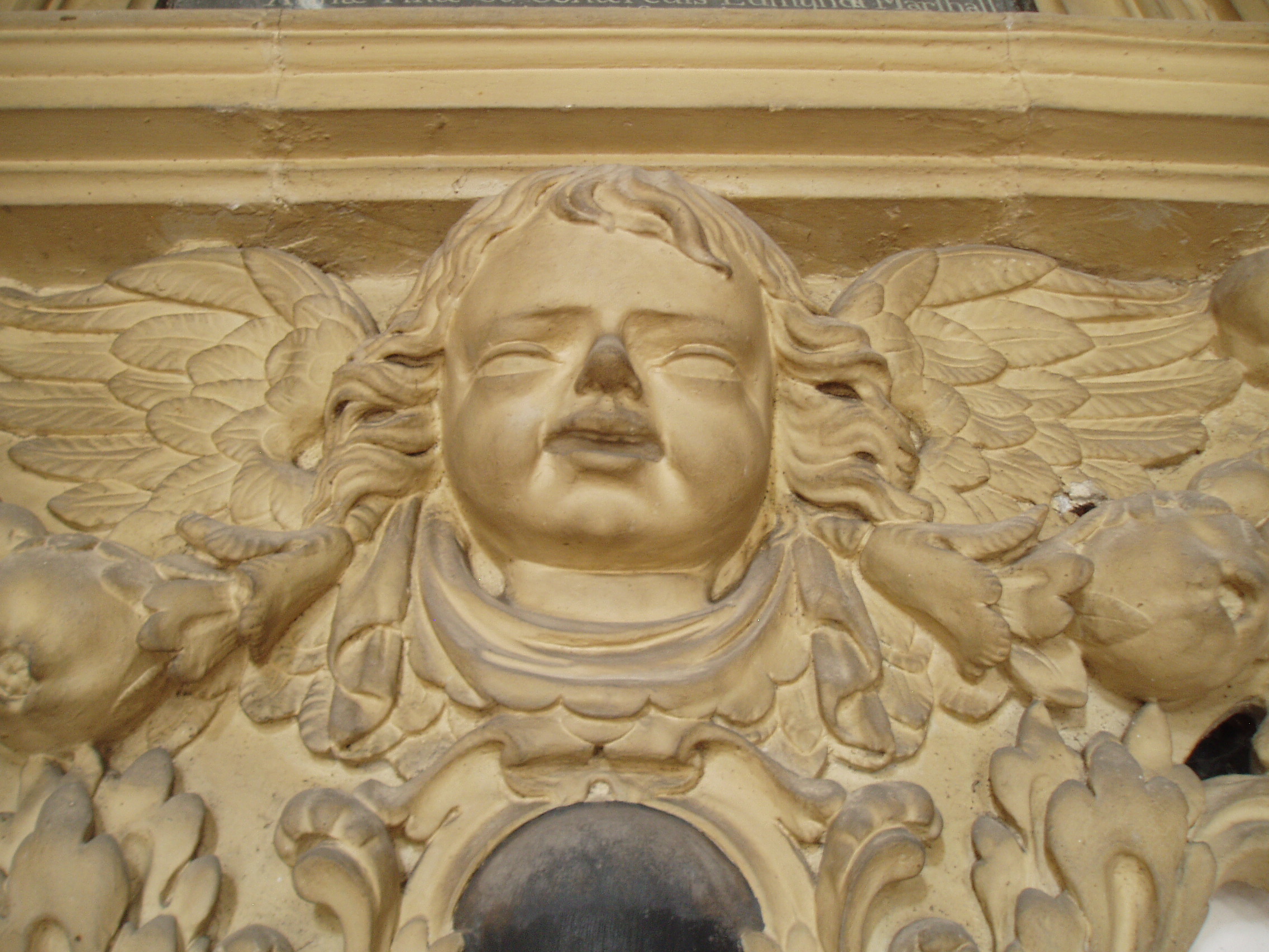 Brydges Memorial, Tyberton Creepy cherub at the base of the Brydges Memorial, one of a group of four impressive wall monuments in the chancel of the Georgian church at Tyberton, Herefordshire.