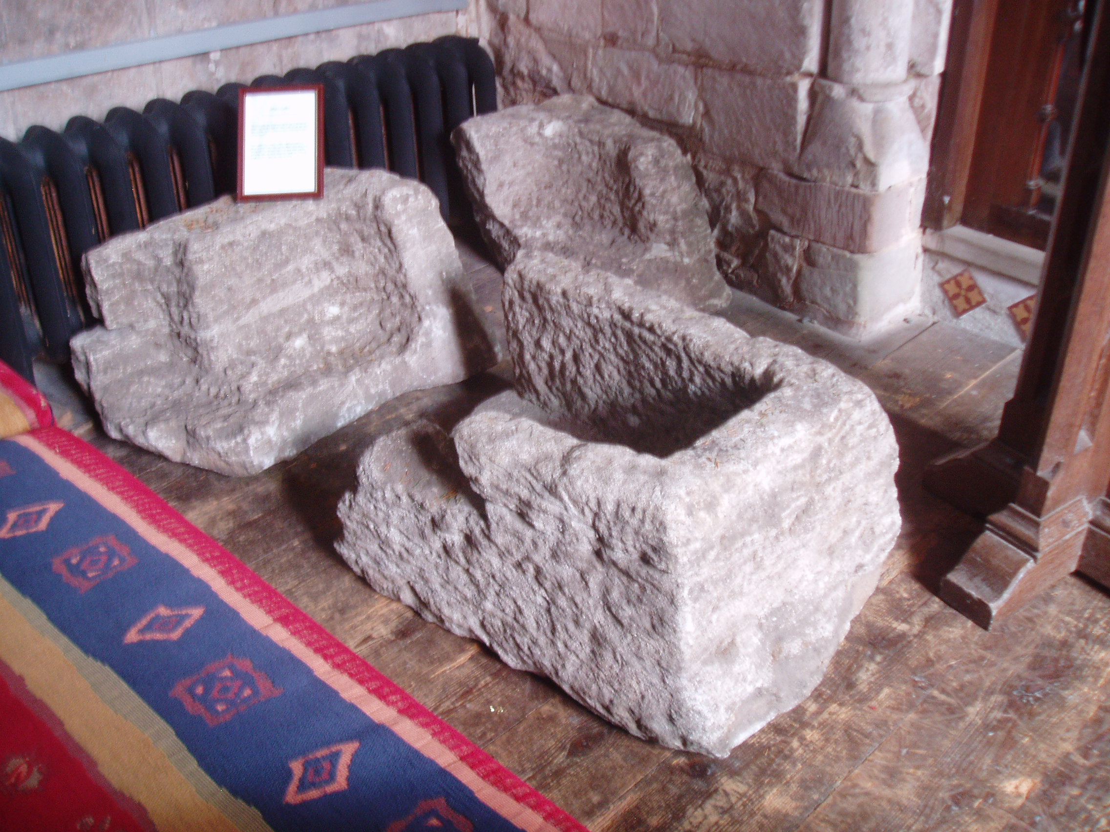 King Offa's Coffin, Offchurch Offchurch owes it's name to an association with Offa, king of Mercia, having reputedly founded the first church here. Fragments of an ancient stone coffin within the present building are believed to have belonged to his burial. The present St Gregory's church is an aiseless largely 12th century building (the windows mostly altered in the 14th century when the chancel was extended) with a 15th century tower. The interior is somewhat gloomy from the Victorian glass that filled every window, though a recently installed abstract window at the west end (by Roger Sargent who lives in the village) casts a serene blue light across the nave. Apart from the remains of Offa's coffin there are several minor wall tablets from the Baroque period.