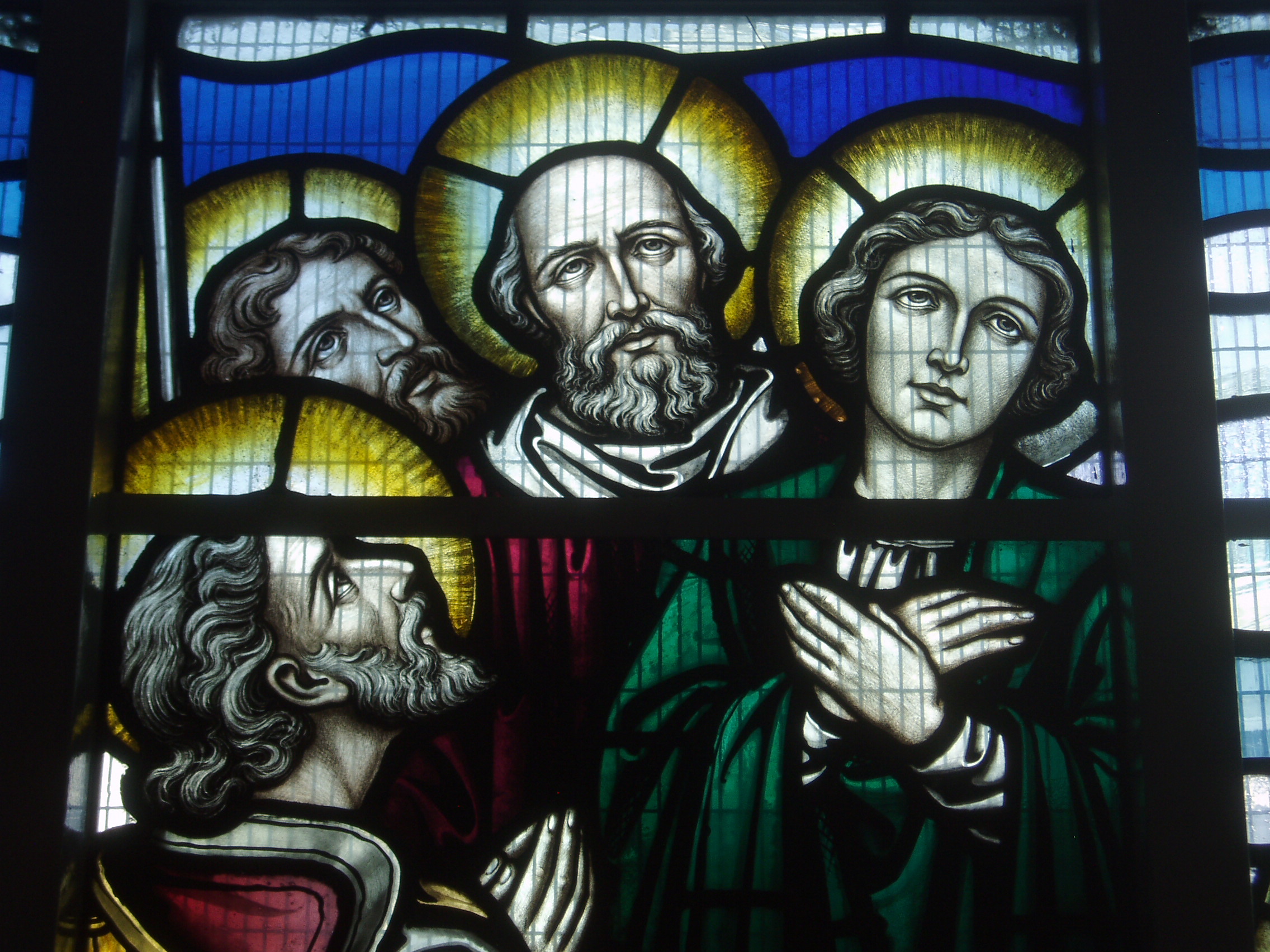 Apostles Stained glass by John Hardman Studios of Birmingham (later than the glass in the main church, closer to c1930) salvaged from the previous church and worked into a new richly coloured abstract setting by the same studio when the church was replaced by a modern building in the 1960s. St Catherine's Roman Catholic church was opened in 1965, having been designed by Harrison & Cox to replace a nearby Victorian structure that was sacrificed to make way for the city's inner ring road in 1961. The church is a major landmark overlooking the A38 leading into the heart of the city, but one I'd never been able to get into until attending a Sunday mass. The internal space is impressive, and somewhat difficult to photograph. It is very much a post Vatican II church, the altar is centrally placed, but not quite in the round as the area behind is divided off to form a separate Lady chapel. The most striking feature for me however was the glass, much of it is salvaged from the previous church and typical Hardman's c1890s, but it has been adapted in a rather unique way with the figurative subjects isolated upon brightly coloured and clearly modern backgrounds to fill the spaces of much larger windows. The effect is far more successful than it might sound and the colour from the rich background glass (also by Hardman's!) really enlivens the interior. www.stcatherinesbirmingham.org/