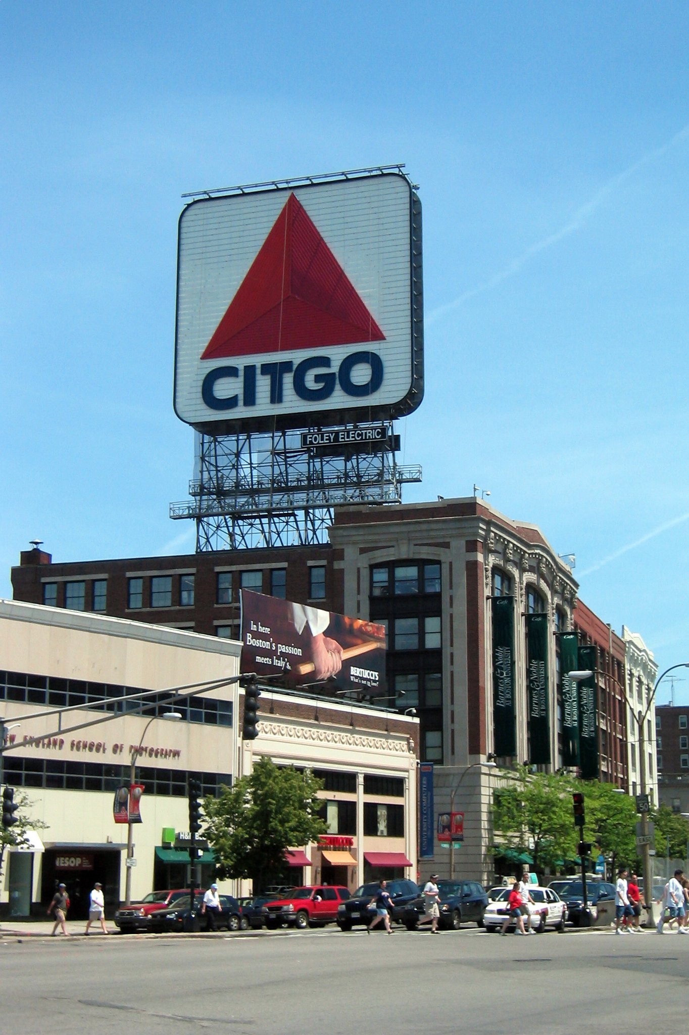 Boston - Kenmore Square: Citgo Kenmore Square exists at the intersection of several Beacon Street, Commonwealth Avenue and Brookline Avenue, abutting Boston University and serving as a transportation hub for nearby Landsdowne Street and Fenway Park. The large, double-faced sign featuring the Citgo "trimark" logo has become a landmark, partly because of its visibility over the Green Monster during televised Red Sox games. The current 60 ft x 60 ft incarnation, unveiled in March 2005 after a six-month restoration project, features thousands of light-emitting diodes (LEDs). LEDs were selected for their durability, energy efficiency, intensity, and ease of maintenance. Earlier versions featured neon lighting; the previous sign contained some 5,878 glass tubes with a total length of over five miles. The first sign, featuring the Cities Service logo, was built in 1940, and replaced with the trimark in 1965. In 1979 Governor Edward J. King ordered it turned off as a symbol of energy conservation. Four years later, Citgo attempted to disassemble the weatherbeaten sign, and was surprised to be met with widespread public affection for the sign and protest at its threatened removal. The Boston Landmarks Commission ordered its disassembly postponed while the issue was debated. While never formally declared a landmark, it was refurbished and relit by Citgo in 1983 and has remained in operation ever since. Citgo is now a subidiary of Petróleos de Venezuela S.A. and in 2006, Jerry McDermott, a Boston city councillor, proposed that the sign be removed in response to Venezuelan President Hugo Chavez's insults toward America . McDermontt also suggested draping an American flag or Boston Red Sox banner over the sign until Chavez is out of office.