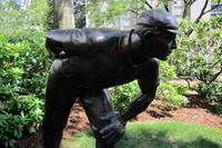 Boston: Northeastern University - Cy Young This portrait statue of Cy Young by sculptor Robert Shure was unveiled in 1993 in front of Churchill Hall, at 360 Huntington Avenue off Forsyth Street, on the campus of Northeastern University. This spot was the site of Huntington Avenue Grounds, or Huntington Avenue American League Base Ball Grounds, the baseball home of the Boston Red Sox (known as the Boston Americans until 1907) from 1901-1911. From this spot, where the pitchers mound used to sit, Young pitched the first game at the Huntington Avenue Grounds in 1901, the first World Series game between the modern American and National leagues in 1903, and the first perfect game in the modern era on May 4, 1904. Huntington Avenue Grounds was the host of four games in that first World Series, where the Boston Americans defeated the Pittsburgh Nationals five games to three. Denton True "Cy" Young (1867-1955) is baseball's all-time winningest pitcher with 511 career wins. Pitching for five different teams during his 22-year career, he established numerous records which have stood for a century including most career innings pitched (7,355), most career games started (815), and most complete games (749). Young's career started with the Cleveland Spiders in 1890 before moving to the St. Louis Perfectos in 1899. In 1901, he jumped to the newly created american League, joining the Boston franchise. He was traded back to Cleveland to play with the Naps before spending the final two months of his career in Boston, this time with the Rustlers in 1911. Young was elected to the Baseball Hall of Fame in 1937. One year after his death, the Cy Young Award was created to honor the previous season's best pitcher.