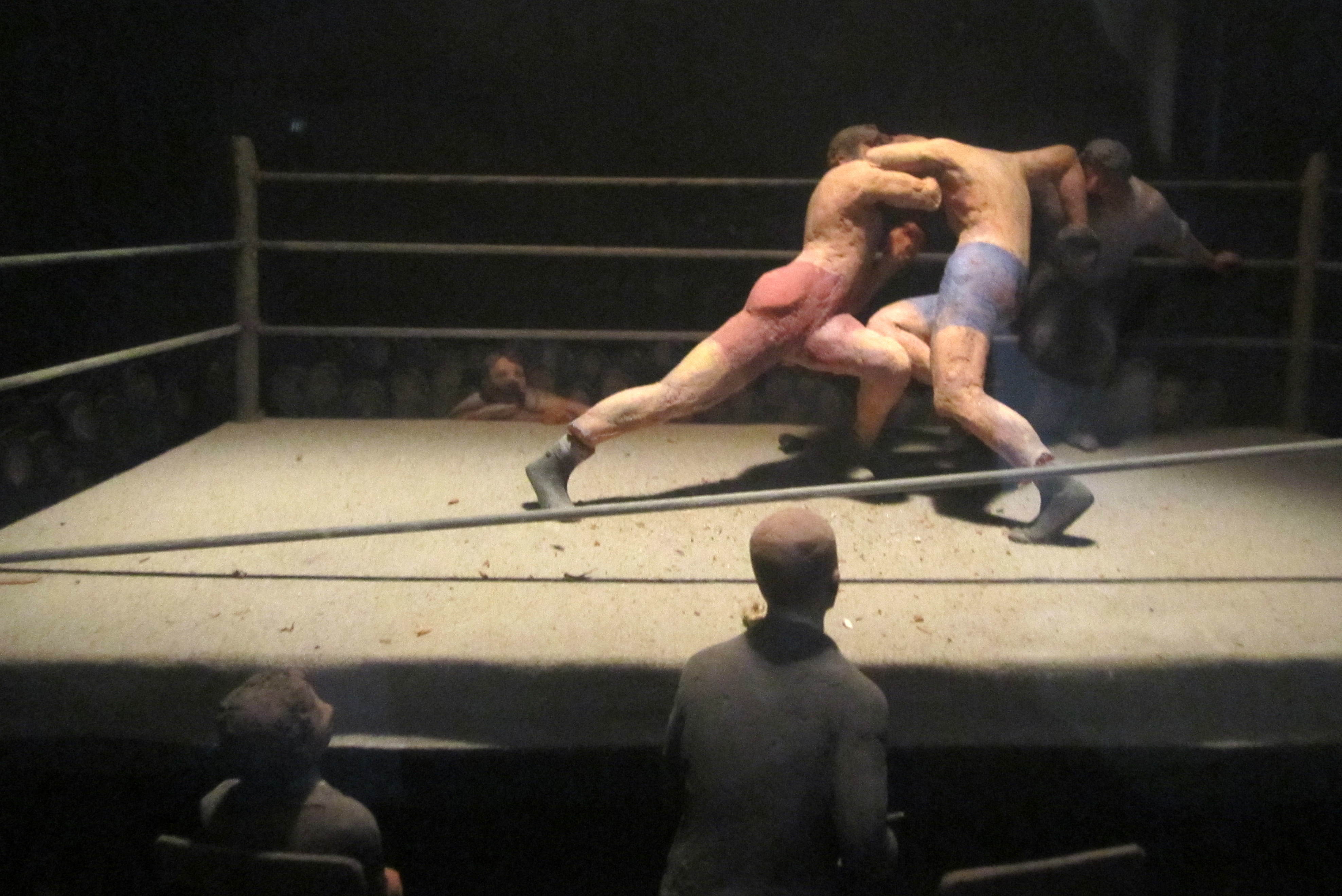 Boston - Back Bay: Boston Public Library McKim Building - Wiggin Gallery Dioramas - George Bellows' Stag at Sharkeys George Bellows, shown in the foreground, watches the boxing match which gave him the subject of his 1917, Stag at Sharkey's. The scene shows a prize fight, known as a ‘stag’, being held at a private club. The boxers are arranged in a strong, pyramid-like composition, recalling classical sculpture. The force of their action is illustrated by interlocking forms and bold diagonal lines. Bellows' lithograph portraying the fight is part of a complete sequence of his prints in the Wiggin Collection. Located in a dark corner in the Wiggins Gallery, twelve dioramas created by Louis Stimson in the 1940's depict artists in the midst of painting some of their most famous works. The Albert H. Wiggin Gallery, originally devoted to special collections, was given over to the exhibiting of prints in 1941 when Mr. Wiggin, a Boston born New York financier, gave the Library his collection of prints and drawings. The Boston Public Library McKim Building, located on Boylston Street between Dartmouth and Exeter Streets, was built in 1895 by Charles Follen McKim of McKim, Mead & White. Consisting of a three-story, monumental free-standing block in the style of an Italian Renaissance palace surrounding an open courtyard, McKim's design was one of the earliest successful examples of Renaissance Beaux-Arts Classicism in America, and set the precedent for grand scale urban libraries. In 1972, the Philip Johnson-designed late modernist wing was added to the Central Library location. The Boston Public Library system, established in 1848, was the country's first publicly supported municipal library, its first large library open to the public and its first to allow citizens to borrow books. There are currently twenty-six branches in the system.