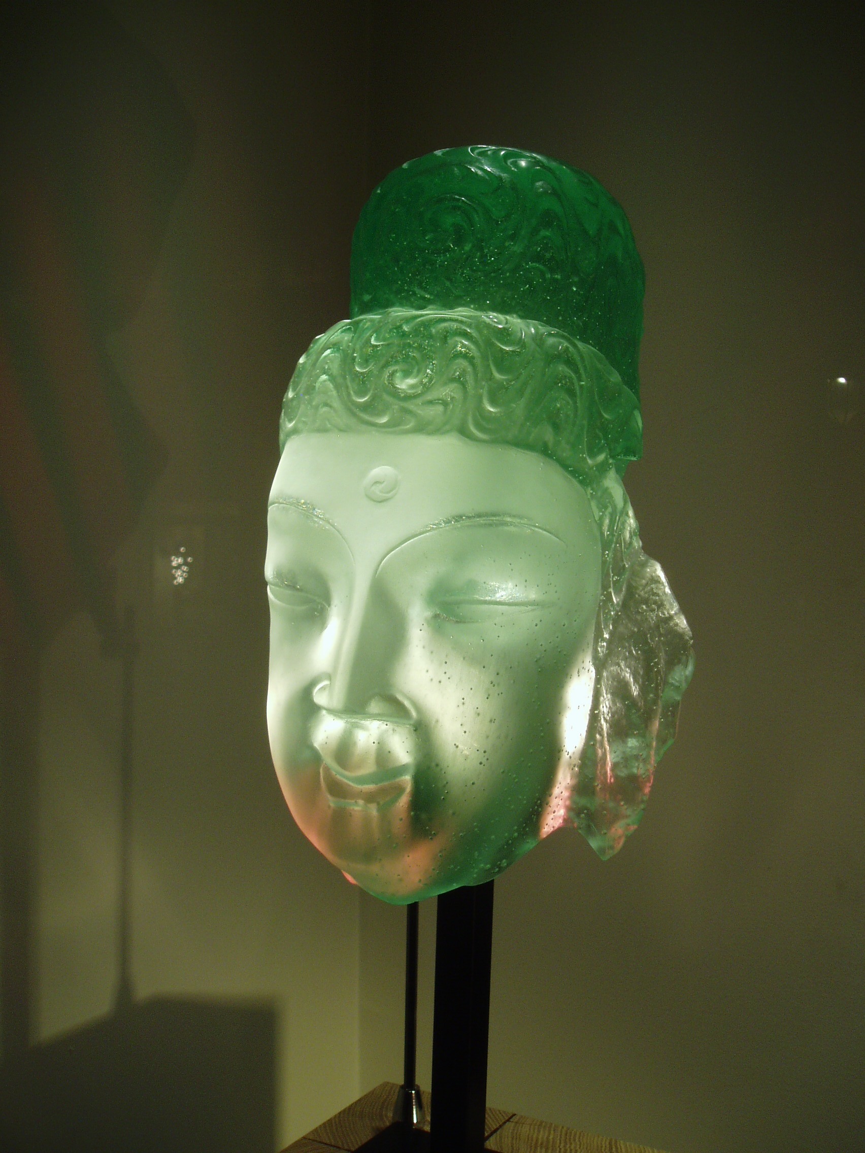 Glass Buddha Part of a window display of beautiful glass sculptures in a shop / gallery close to Place Stanislaus in Nancy.