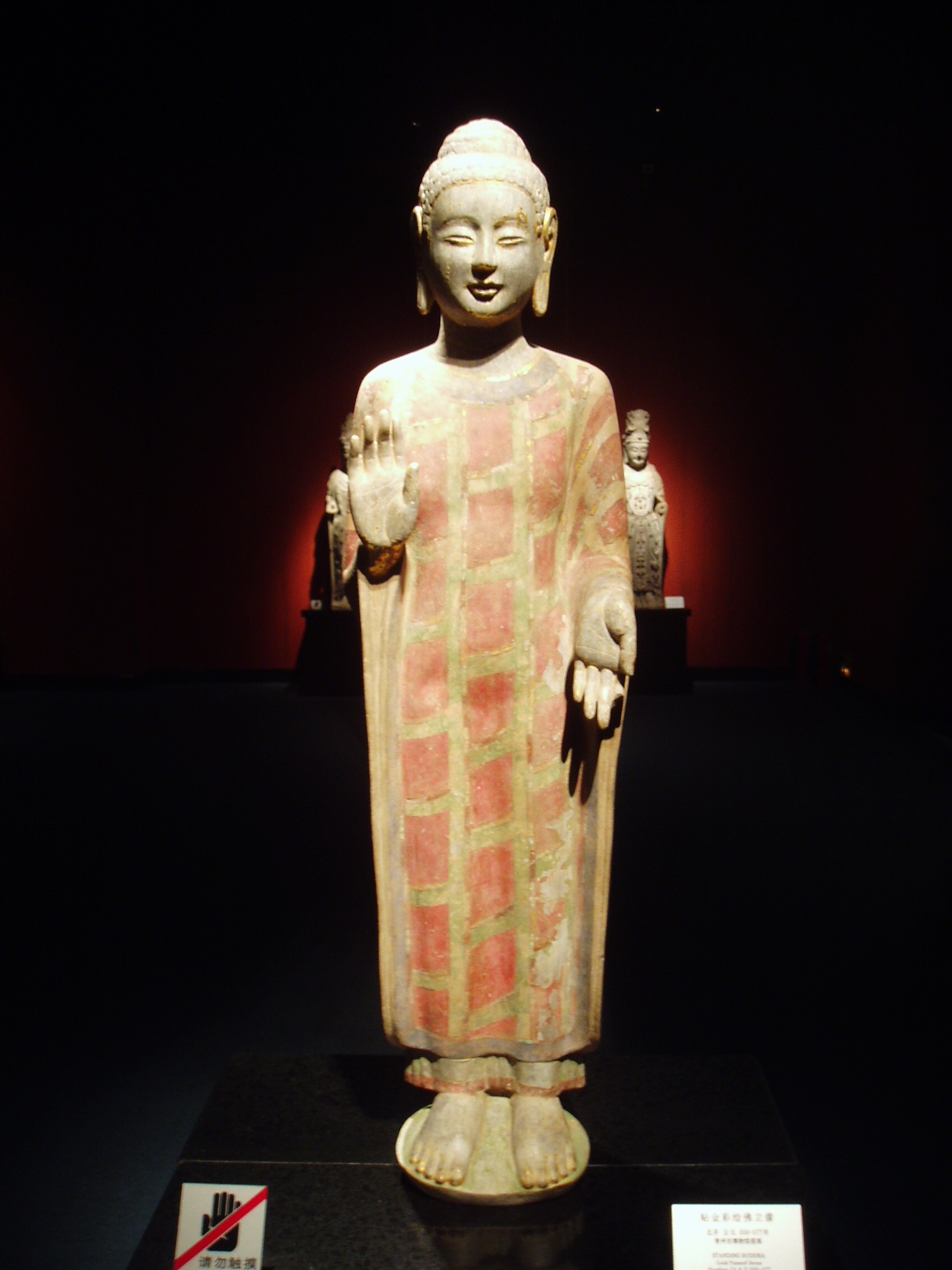 Buddha Ancient religious sculpture housed in the ground floor gallery of the Shanghai Museum. Shanghai's Museum of Ancient Chinese Art is housed in a major work of modern architecture (built in 1995 in a form symbolising 'a round heaven and a square earth', also reminiscent of an ancient Chinese cooking bowl) on the southern edge of Renmin Square. The collections are housed on several different floors arranged around an open, central hall from which all galleries are accessed by stair or lift. We only had limited time to explore the collections so focused on the impressive galleries of sculpture in stone, bronze and ceramic.