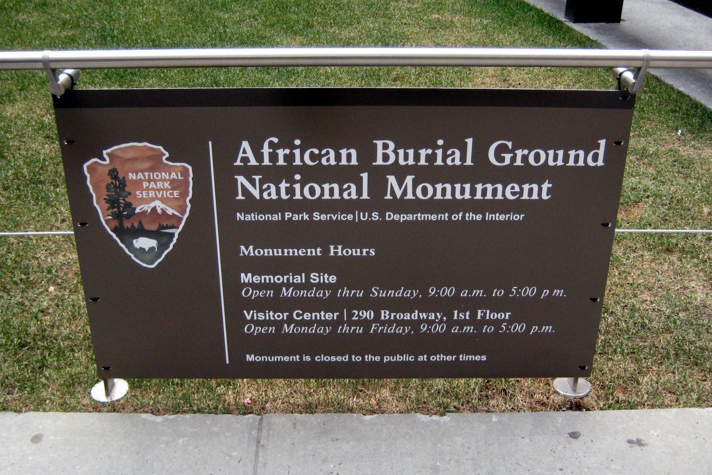 NYC - Civic Center: African Burial Ground National Monument During the preliminary construction phase of a new Federal office building at 290 Broadway in 1991, workers discovered the remains of more than 400 Africans stacked in wooden boxes just 16 to 28 feet below street level. Construction on what was to become a $276 million U.S. General Services Commission building was halted immediately, and a subsequent archeological investigation unearthed the remnants of a five- to six-acre African burial ground used throughout the 17th and 18th centuries. Initially, the federal government resisted permanent discontinuation. owever, the overwhelming response from the African-American community, including then Mayor David Dinkins, in the form of protests, vigils, public meetings, and religious observances eventually won the support of the federal government. Enslaved Africans began arriving on the shores of the colony of New Amsterdam as early as 1626, and the area known today as New York City was one of the largest slave trading centers (second only to Charleston, South Carolina) throughout the colonial period. The Burial Ground, though, wasn't created until the early 1700s, when Trinity Church banned all Africans from its cemetery, leaving them relegated to a deserted area, then more than a mile outside the city limit, to bury their dead. As the city began to expand throughout the 18th century, it appropriated the space occupied by the African Burial Ground and covered the site with landfill and debris from the nearby leather and pottery industries. By the time slavery was abolished in New York -- on Emancipation Day, July 4, 1827 -- many had long forgotten about the burial ground. At the time of its discovery in 1991, the African Burial Ground was recognized as the largest and only known urban pre-Revolutionary African cemetery in the country. In 1993, the federal government declared the site a National Historic Landmark. Between the time of its discovery and its designation as a historic landmark, urban archeologists exhumed the remains of more than 400 African adults and children, along with various artifacts such as beads, coins, and shells, and transported them to Washington, D.C.'s Howard University. In September 2005, ground was broken for a $3 million memorial, located at Duane and Elk Streets, commemorating the lives of 20,000 enslaved Africans who were laid to rest in the Civic Center area in the 17th and 18th centuries. Though most remains were exhumed, more than 400 were ceremoniously reinterred in October 2003. Designed by architect Rodney Léon, the soaring, circular memorial is home to a wall of remembrance, ancestral pillars, a spiral processional ramp, and a "Circle of the Diaspora," which features symbols and images of African, Latin American, and Caribbean cultures. The U.S. General Services Administrationfunded the memorial, which was built and maintained in collaboration with the National Parks Service. NPS declared the site a National Monument in fall 2007. National Historic Register #93001597