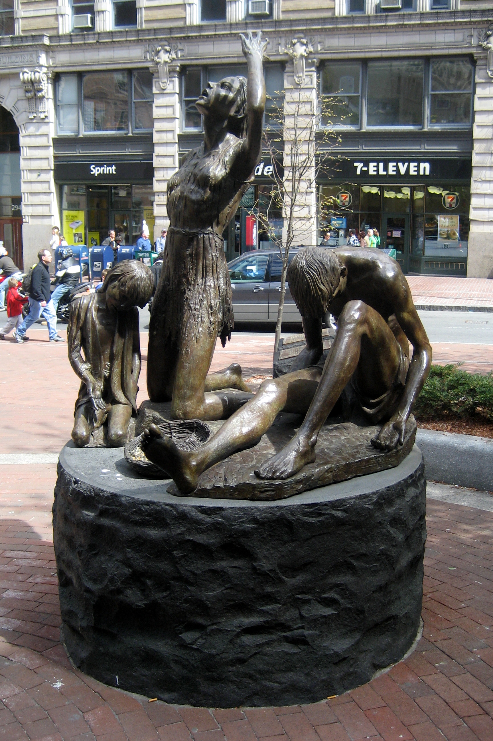 Boston: Boston Irish Famine Memorial To commemorate the 150th anniversary of the Irish Famine, where one million people were killed and another two million forced to flee Ireland, Boston's Irish community unveiled a $1 million memorial park on June 28, 1998. Sculpted by Robert Shure, the memorial features two life-size sculptures--one (pictured here) depicting a family leaving Ireland's shores, impoverished and desperate; and another depicting a family arriving in Boston, filled with hope and determination. Over 100,000 Irish refugees came to Boston between 1845 and 1849, transforming the city. Despite 'No Irish Need Apply' signs and other anti-Irish discrimination in Boston, the Irish ultimately prevailed, taking over the city government. The memorial park is located in downtown Boston, the park is sited along the city's Freedom Trail at the corner of Washington and School Streets, near Downtown Crossing, just a few blocks from where the Irish refugees first crowded into tenements along Boston's waterfront. Shure, a Brooklyn native was a unanimous selection in an international competition to design the memorial. He has produced a number of significant sculptures, notably the Korean War Monument in The Charlestown Navy Yard and the George Washington Memorial at the Washington Monument in Washington D.C. His local work includes the Ted Williams Tunnel plaque, the Boston police and firemen sculpture at International Place, the American Family monument at Norwood Town Common, the bronze sculptures of marathon runners at Copley Square Park, and the since removed giant teddy bear in front of F.A.O. Schwarz store in Back Bay.