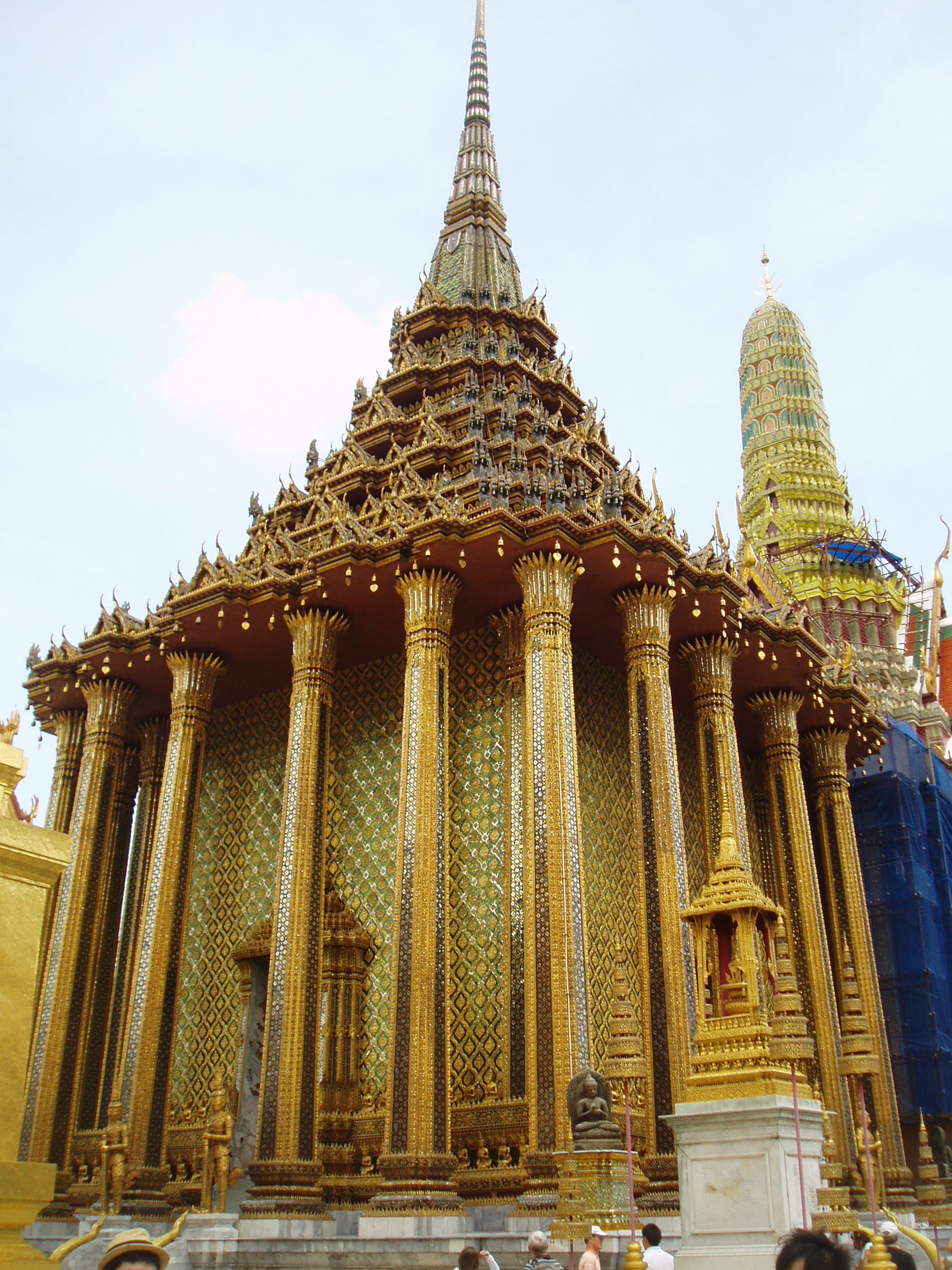 Phra Mondop, Wat Phra Kaew, Bangkok Bangkok's most unmissable attraction is of course the Grand Palace, and most specifically the temple complex of Wat Phra Kaew (Temple of the Emerald Buddha), famed for it's riot of coloured and gilded ornament, paintings and sculptures; quite simply, so visually stunning there is nothing quite like it anywhere else! The Palace and Temple complex were begun in 1782, the year the capital was moved to Bangkok, and parts of the palace buildings betray 18th century European influence combined with traditional Thai style, such as the breathtaking gilt spires on the roof. Most of the interiors of the Palace itself are off limits to visitors since, although no longer the main residence of the thai monarchy, it is frequently used for state functions and ceremonies. The Wat Phra Kaew complex however is the greatest draw, famed for it's stunning architecture and the famous 'Yaksha' guardian figures that flank all the main entrances to the complex. These towering figures, with their rich colours and tapering crowns, represent demonic characters from the mythological epic the 'Ramakien', and are identifiable as distinct individuals, all here serving a benign, protective role. The Ramakien is also the subject for a stunning sequence of wall paintings within the cloister that encirlces the entire site, illustrating in minute detail the battles of the heroic monkey warriors, led by the monkey god Hanuman, against the demonic armies and kingdoms of Tosakan. The Temple of the Emerald Buddha itself forms the largest structure and contains the venerated (though small) Buddha image. The complex contains several other iconic buildings clad in sumptuous decor, most notably the library or 'mondop' with it's gilt spire along with the great golden stupa. The temple complex is technically a royal chapel rather than a working monastery like most Thai temples as it has no resident monks (the sheer volume of visitors leaves little room for anyone else anyway!). en.wikipedia.org/wiki/Wat_Phra_Kaew en.wikipedia.org/wiki/Grand_Palace