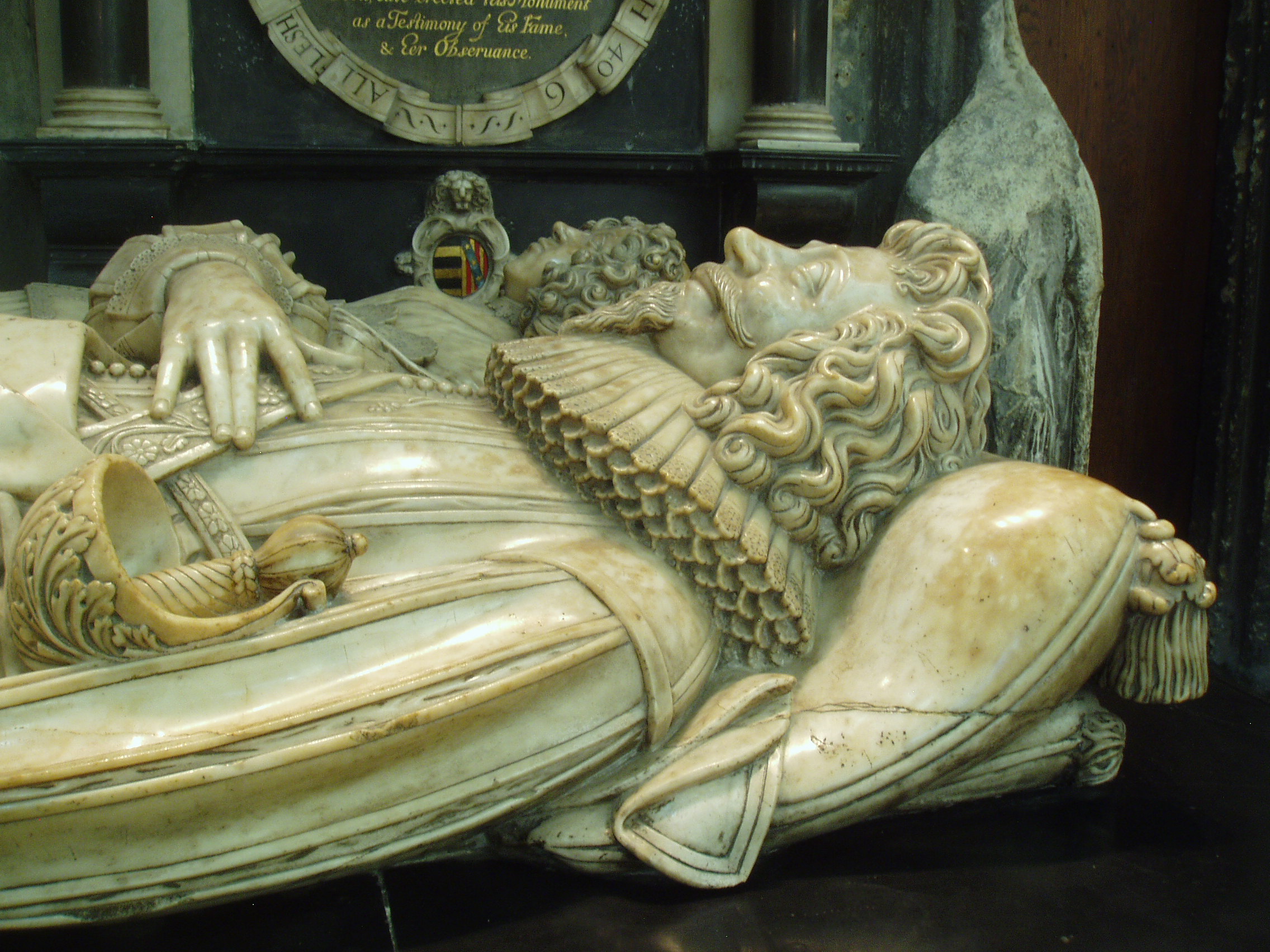 Abraham & Gertrude Blackleech Detail of the tomb of Abraham & Gertrude Blackleech in the south transept at Gloucester. The monument dates from 1639 and is the work of an unknown highly skilled sculptor, similar to the work of Nicholas Stone. Gloucester Cathedral is one of England's finest churches, a masterpiece of medieval architecture consisting of a uniquely beautiful fusion of Norman Romanesque and Perpendicular Gothic from the mid 14th century onwards. Until the Reformation this was merely Gloucester's Abbey of St Peter, under Henry VIII it became one of six former monastic churches to be promoted to cathedral status, thus saving the great church from the ravages of the Dissolution. The most obviously Norman part is the nave, immediately apparent on entering the building with it's round arches and thick columns (the exterior is the result of Gothic remodelling). Much of the remainder of the building is substantially the Norman structure also, but almost entirely modified in the later Middle Ages inside and out, the result of the great revenue brought to the abbey by pilgrims to the tomb of the murdered King Edward II in the choir. It was this transformation of the Norman church that is credited with launching the late gothic Perpendicular style in England. The gothic choir is a unique and spectacular work, the walls so heavily panelled as to suggest a huge stone cage (disguising the Norman arches behind) crowned by a glorious net-like vault adorned with numerous bosses (those over the Altar with superb figures of Christ and angels) whilst the east wall is entirely glazing in delicate stone tracery, and still preserving most of it's original 14th century stained glass. The soaring central tower, also richly panelled with delicate pinnacles, is another testament to the abbey's increasing wealth at this time. The latest medieval additions to the church are equally glorious, the Lady Chapel is entered through the enormous east window and is itself a largely glazed structure, though the original glass has been reduced to a few fragments in the east window, the remainder now contains beautiful Arts & Crafts stained glass by Christopher and Veronica Whall. The early 16th century cloisters to the north of the nave are some of the most beautiful anywhere, being completely covered by exquisite fan vaulting, with a seperate lavatorium (washing room) attached to the north walk as a miniature version of the main passages. There is much more of interest, from 14th century choir stalls with misericords to the comprehensive collection of tombs and monuments of various dates, including the elaborate tomb of Edward II and that of Robert Duke of Normandy, eldest son of William the Conqueror. The stained glass also represents all ages, from the 14th century to the striking contemporary windows by Tom Denny. Further areas of the cathedral can be accessed at certain times, such as the Norman crypt under the choir and the triforium gallery above. www.gloucestercathedral.org.uk/ My visit coincided with the major 'Crucible' exhibition of contemporary sculpture (September-October 2010), examples of which I will upload in due course.