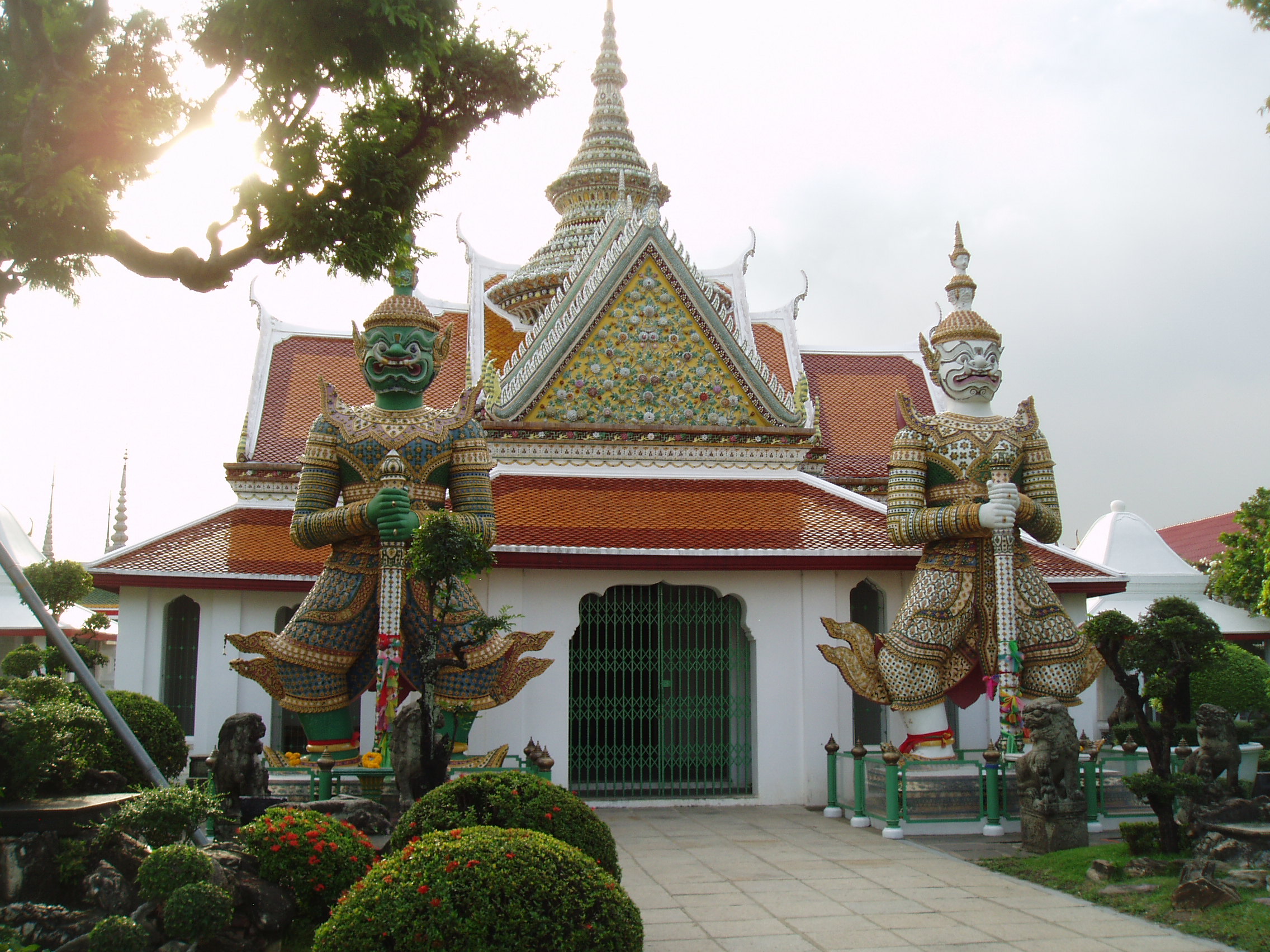 Temple Guardians, Wat Arun, Bangkok The Ordination Hall guarded by Yaksha giants (benign demons) in the precinct of Wat Arun (Temple of Dawn) on Bangkok's west bank. en.wikipedia.org/wiki/Wat_Arun