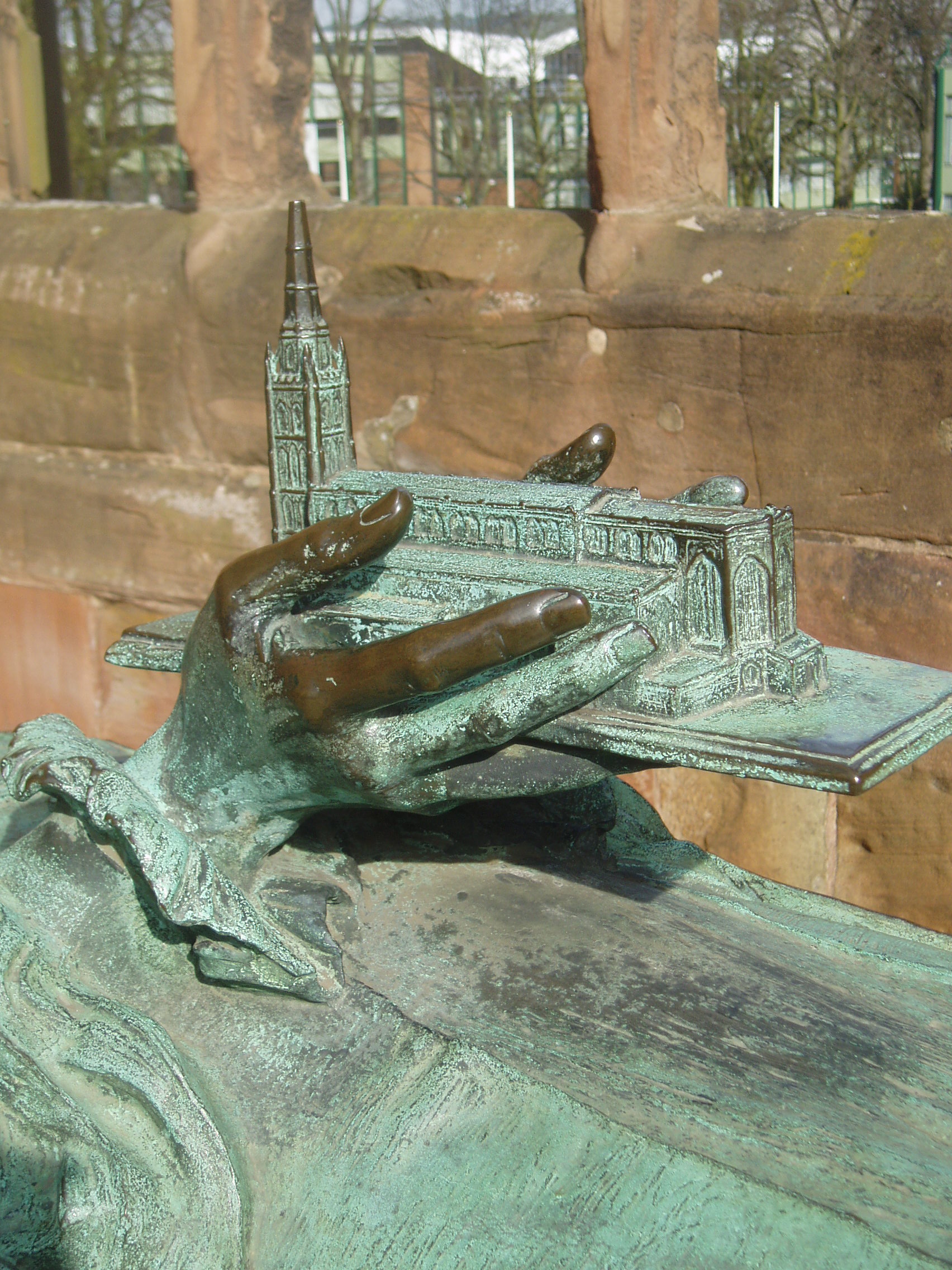 Old Coventry Cathedral in Miniature Detail of the memorial of Bishop Yeatman Biggs, first bishop of te newly refounded Diocese of Coventry (d.1922). The bronze effigy by Sir John Hamo Thornycroft was the only one of the old St Michael's many monuments to survive the bombing more or less intact. (It remains unclear what fragments survived in the debris of the important Tudor Nethermyll and Swillington tombs or what was done with them; old photos suggest something of the latter survived but no trace remains today). Coventry's Cathedral is a unique synthesis of old a new, born of wartime suffering and forged in the spirit of postwar optimism, famous for it's history and for being the most radically modern of Anglican cathedrals. Two cathedral's stand side by side, the ruins of the medieval building, destroyed by incendiary bombs in 1940 and the bold new building designed by Basil Spence and opened in 1962. It is a common misconception that Coventry lost it's first cathedral in the wartime blitz, but the bombs actually destroyed it's second; the original medieval cathedral was the monastic St Mary's, a large cruciform building believed to have been similar in appearance to Lichfield Cathedral (whose diocese it shared). Tragically it became the only English cathedral to be destroyed during the Reformation, after which it was quickly quarried away, leaving only scant fragments, but enough evidence survives to indicate it's rich decoration (some pieces displayed nearby in the Priory Visitors Centre). Foundations of it's apse were found during the building of the new cathedral in the 1950s, thus technically three cathedrals share the same site. The mainly 15th century St Michael's parish church became the seat of the new diocese of Coventry in 1918, and being one of the largest parish churches in the country it was upgraded to cathedral status without structural changes (unlike most 'parish church' cathedrals created in the early 20th century). It lasted in this role a mere 22 years before being burned to the ground in the 1940 Coventry Blitz, leaving only the outer walls and the magnificent tapering tower and spire (the extensive arcades and clerestoreys collapsed completely in the fire, precipitated by the roof reinforcement girders, installed in the Victorian restoration, that buckled in the intense heat). The determination to rebuild the cathedral in some form was born on the day of the bombing, however it wasn't until the mid 1950s that a competition was held and Sir Basil Spence's design was chosen. Spence had been so moved by experiencing the ruined church he resolved to retain it entirely to serve as a forecourt to the new church. He envisaged the two being linked by a glass screen wall so that the old church would be visible from within the new. Built between 1957-62 at a right-angle to the ruins, the new cathedral attracted controversy for it's modern form, and yet some modernists argued that it didn't go far enough, afterall there are echoes of the gothic style in the great stone-mullioned windows of the nave and the net vaulting (actually a free-standing canopy) within. What is exceptional is the way art has been used as such an integral part of the building, a watershed moment, revolutionising the concept of religious art in Britain. Spence employed some of the biggest names in contemporary art to contribute their vision to his; the exterior is adorned with Jacob Epstein's triumphant bronze figures of Archangel Michael (patron of the cathedral) vanquishing the Devil. At the entrance is the remarkable glass wall, engraved by John Hutton with strikingly stylised figures of saints and angels, and allowing the interior of the new to communicate with the ruin. Inside, the great tapestry of Christ in majesty surrounded by the evangelistic creatures, draws the eye beyond the high altar; it was designed by Graham Sutherland and was the largest tapestry ever made. However one of the greatest features of Coventry is it's wealth of modern stained glass, something Spence resolved to include having witnessed the bleakness of Chartres Cathedral in wartime, when all it's stained glass had been removed. The first window encountered on entering is the enormous 'chess-board' baptistry window filled with stunning abstract glass by John Piper & Patrick Reyntiens, a symphony of glowing colour. The staggered nave walls are illuminated by ten narrow floor to ceiling windows filled with semi-abstract symbolic designs arranged in pairs of dominant colours (green, red, multi-coloured, purple/blue and gold) representing the souls journey to maturity, and revealed gradually as one approaches the altar. This amazing project was the work of three designers lead by master glass artist Lawrence
