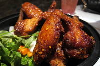 NYC - LES: Pok Pok Wing - Ike's Wings Ike's Wings are fresh natural whole chicken wings marinated in fish sauce, garlic and sugar, deep fried, tossed in carmelized Phu Quoc fish sauce and garlic and served with Vietnamese table salad. They were named one fo the 10 best restaurant dishes in America 2007 by Food & Wine Magazine and have been featured on the Food Network programs Best Thing I Ever Ate and Diners, Drive-in's and Dives. Pok Pok Wing, located at 137 Rivington Street, opened on January 19, 2012, bringing chef-owner Andy Ricker's cultishly loved Vietnamese fish sauce wings from Portland to New York. It is the first location outside of the Portland area for Ricker, the 2011 James Beard award for Best Chef Northwest, who first opened Pok Pok in 2005. His creations at Pok Pok lean heavily on the street food culture of northern Thailand that he observed throughout his extensive travels. Later in the year, Ricker opened up the full menu Pok Pok NY in Brooklyn's Columbia Waterfront.