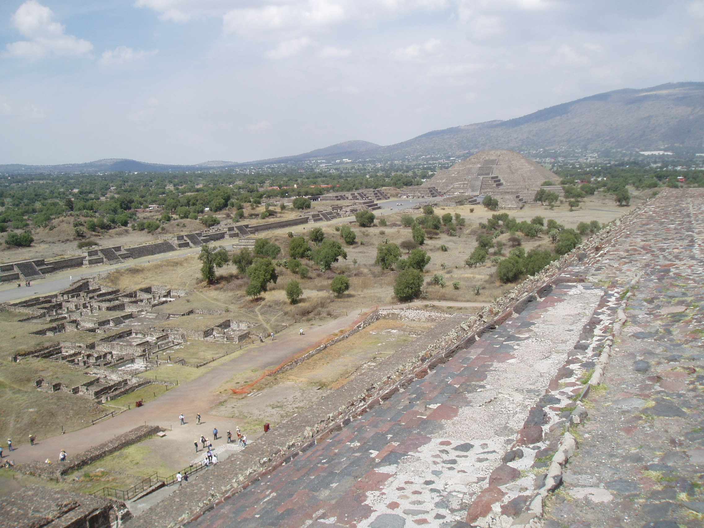Avenue of the Dead, Teotihuacan Teotihuacan is one of the most famous and important sites of ancient Mexico, best known for it's enormous Avenue of the Dead and the great pyramids of the Sun and Moon. Although the site was known in Aztec times as the 'Birthplace of the Gods' it is actually significantly older, with most of the major structures built between 100-250AD and the city, one of the largest ever ancient settlements in the Americas, was believed to have been still inhabited up to the 8th century. Today the vast scale of the complex, particularly the so called Avenue of the Dead, nearly 3km long and flanked by ancient ruins and terraces, continues to awe visitors. At the north end of the Avenue sits the Pyramid of the Moon, whilst it's much larger counterpart, the Pyramid of the Sun, sits halfway up it's eastern side. At the southern end sits the Ciudadela complex which centres on the smaller pyramid of Quetzelcoatl, earlier and more ruined than the larger pyramids but retaining it's stunning original sculptural decoration on part of it's western face, featuring the iconic feathered serpent heads. Aside from the great ceremonial structures there are also residential buildings, particularly the palatial complex at the north west corner that retains some vivid fragments of it's original mural decoration. en.wikipedia.org/wiki/Teotihuacan