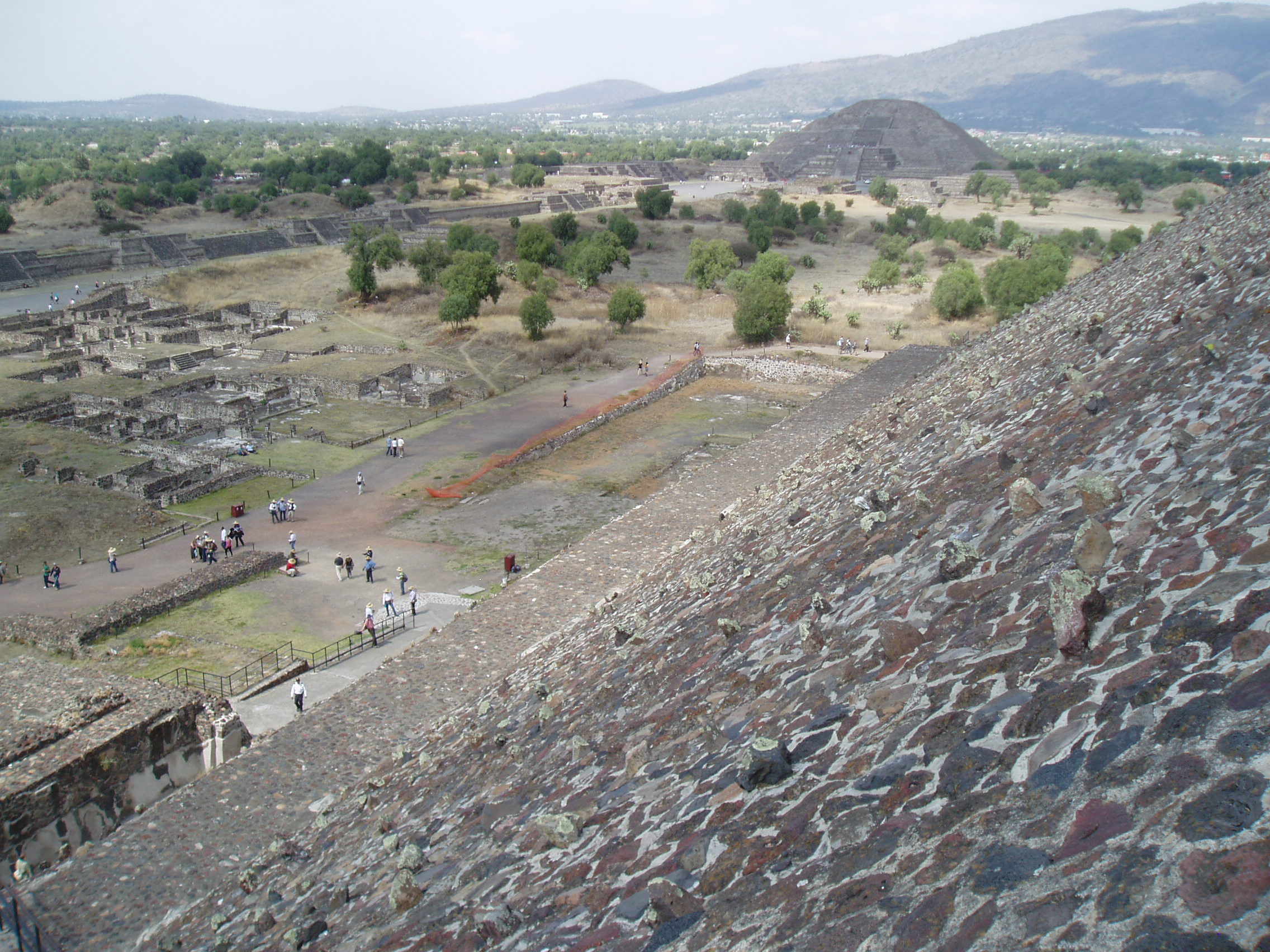 Teotihuacan Teotihuacan is one of the most famous and important sites of ancient Mexico, best known for it's enormous Avenue of the Dead and the great pyramids of the Sun and Moon. Although the site was known in Aztec times as the 'Birthplace of the Gods' it is actually significantly older, with most of the major structures built between 100-250AD and the city, one of the largest ever ancient settlements in the Americas, was believed to have been still inhabited up to the 8th century. Today the vast scale of the complex, particularly the so called Avenue of the Dead, nearly 3km long and flanked by ancient ruins and terraces, continues to awe visitors. At the north end of the Avenue sits the Pyramid of the Moon, whilst it's much larger counterpart, the Pyramid of the Sun, sits halfway up it's eastern side. At the southern end sits the Ciudadela complex which centres on the smaller pyramid of Quetzelcoatl, earlier and more ruined than the larger pyramids but retaining it's stunning original sculptural decoration on part of it's western face, featuring the iconic feathered serpent heads. Aside from the great ceremonial structures there are also residential buildings, particularly the palatial complex at the north west corner that retains some vivid fragments of it's original mural decoration. en.wikipedia.org/wiki/Teotihuacan