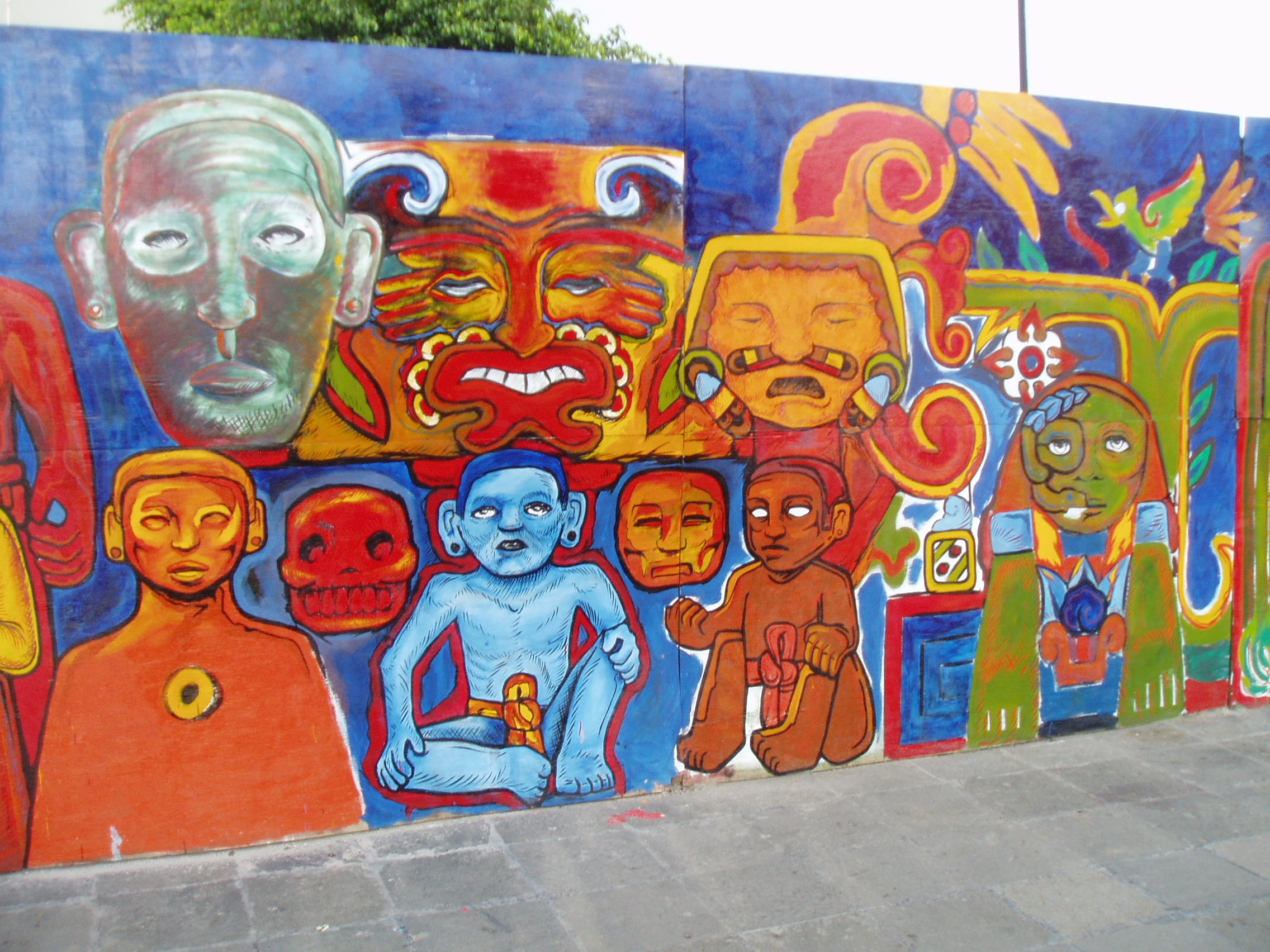 Aztec Characters Temporary mural decoration representing traditional Aztec cultural artefacts and deites, decorating a partition separating the archaeological area of the Templo Major from the Cathedral precinct in Mexico City.