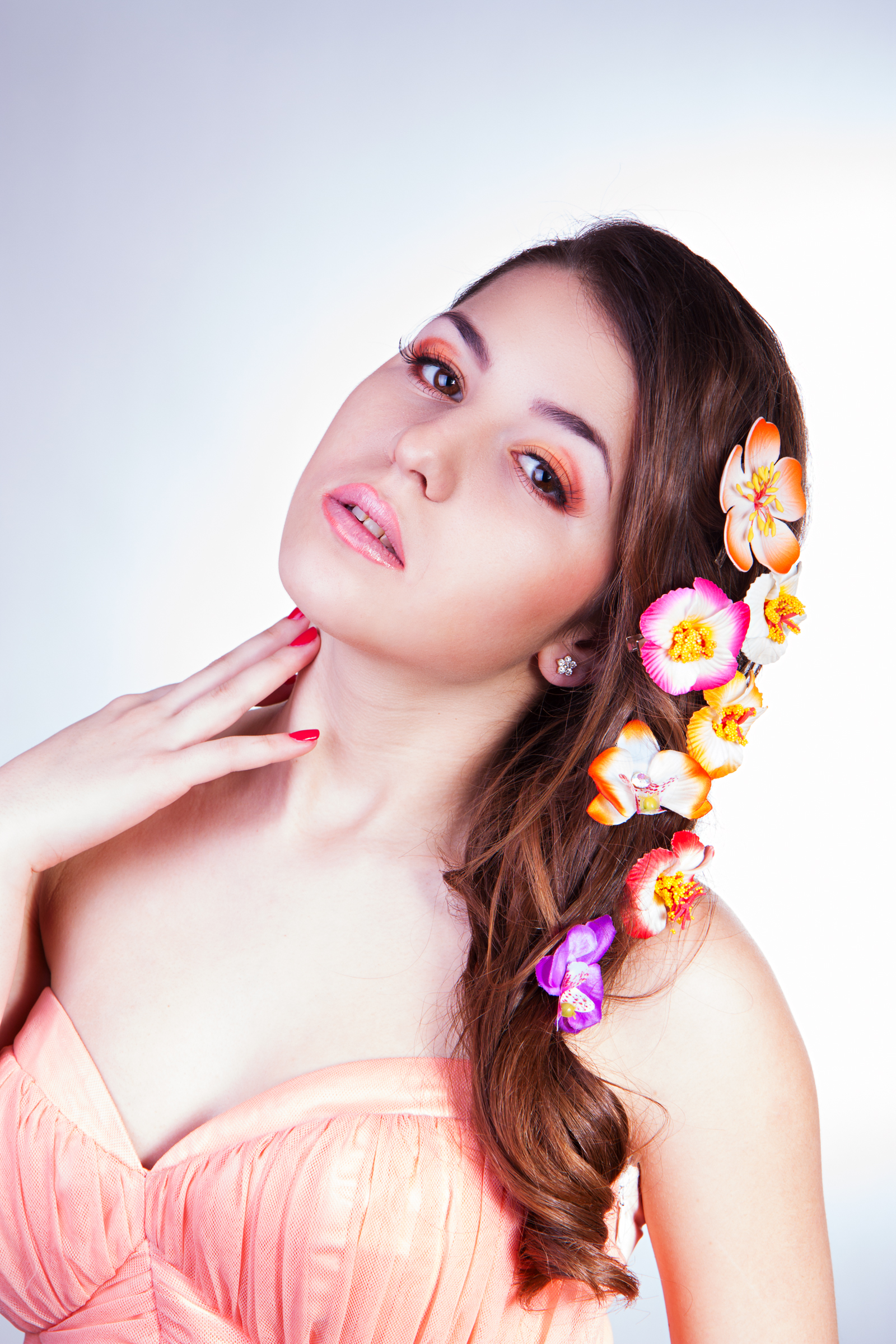 beautiful girl with flowers in hair touches her skin by hand