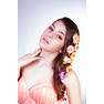 beautiful girl with flowers in hair touches her skin by hand