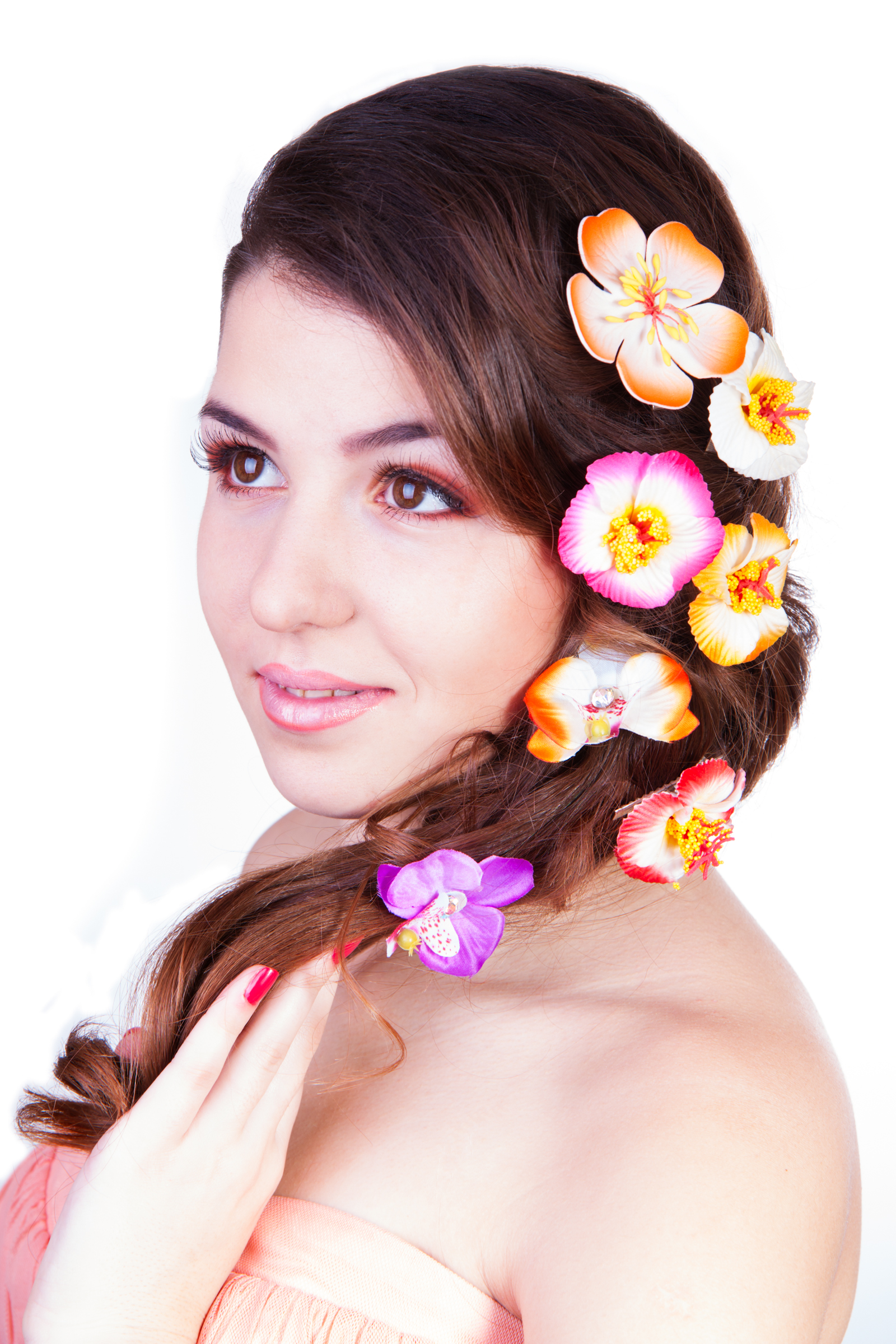 portrait of beautiful woman with flowers touchg her hair by hand