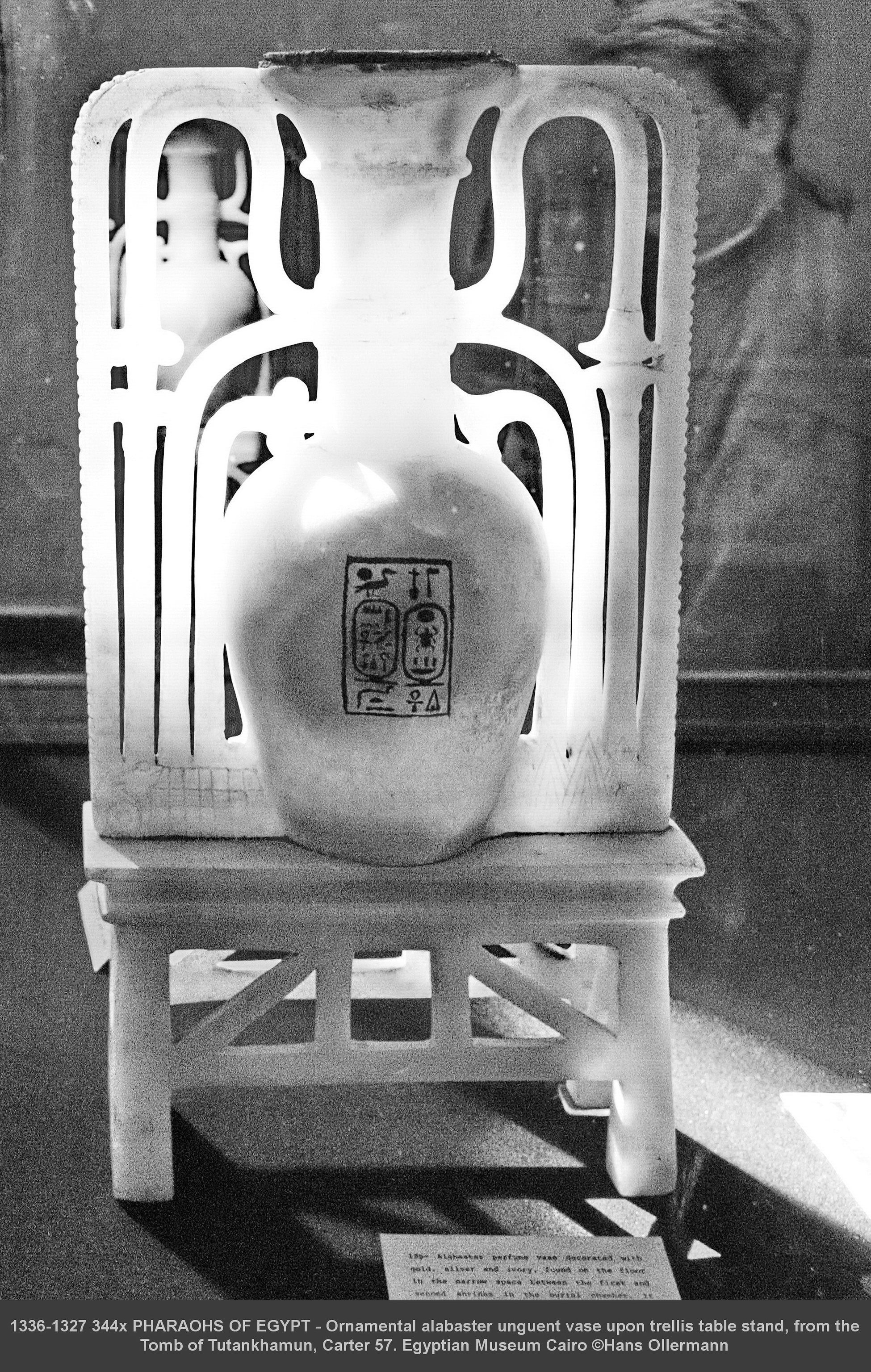 Ornamental alabaster unguent vase upon trellis table stand, from the Tomb of Tutankhamun, Carter 57. Egyptian Museum Cairo :copyright:Hans Ollermann Carter 57 Relevant Burton photo’s as found in Howard Carter Archives in the unsurpassed Griffith Institute Oxford are 468, 475-477 and 1641. JE 62116. Exh. 6.