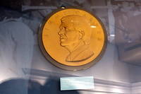 Atlanta - Poncey-Highland: Jimmy Carter Library and Museum - Inaugural Medal This large, gold-planted plaster cast shows the design of the official inaugural medal created for President Carter by Julian H. Harris of Georgia. The Jimmy Carter Library and Museum, located on the site where Union General William T. Sherman orchestrated the Battle of Atlanta in 1864 at 441 Freedom Parkway, was opened to the public on October 1, 1986. James Earl "Jimmy" Carter, Jr. served as the 39th President of the United States from 1977 to 1981 following two terms as a Georgia State Senator, representing the 14th district, and one as the 76th Governor of Georgia, from 1971 to 1975. The museum and library, run by the National Archives and Records Administration as part of the Presidential Library system, are housed in a 69,750 square feet building with 15,269 square feet of space for exhibits and 19,818 square feet of archive and storage space. The library stacks house 27 million pages of documents; 500,000 photos, and 40,000 objects, along with films, videos, and audiotapes covering cover all areas of the Carter administration, from foreign and domestic policy to the personal lives of President and Mrs. Carter. Privately owned areas of the complex ouse Carter's offices and the offices of the Carter Center, a non-profit human rights agency.