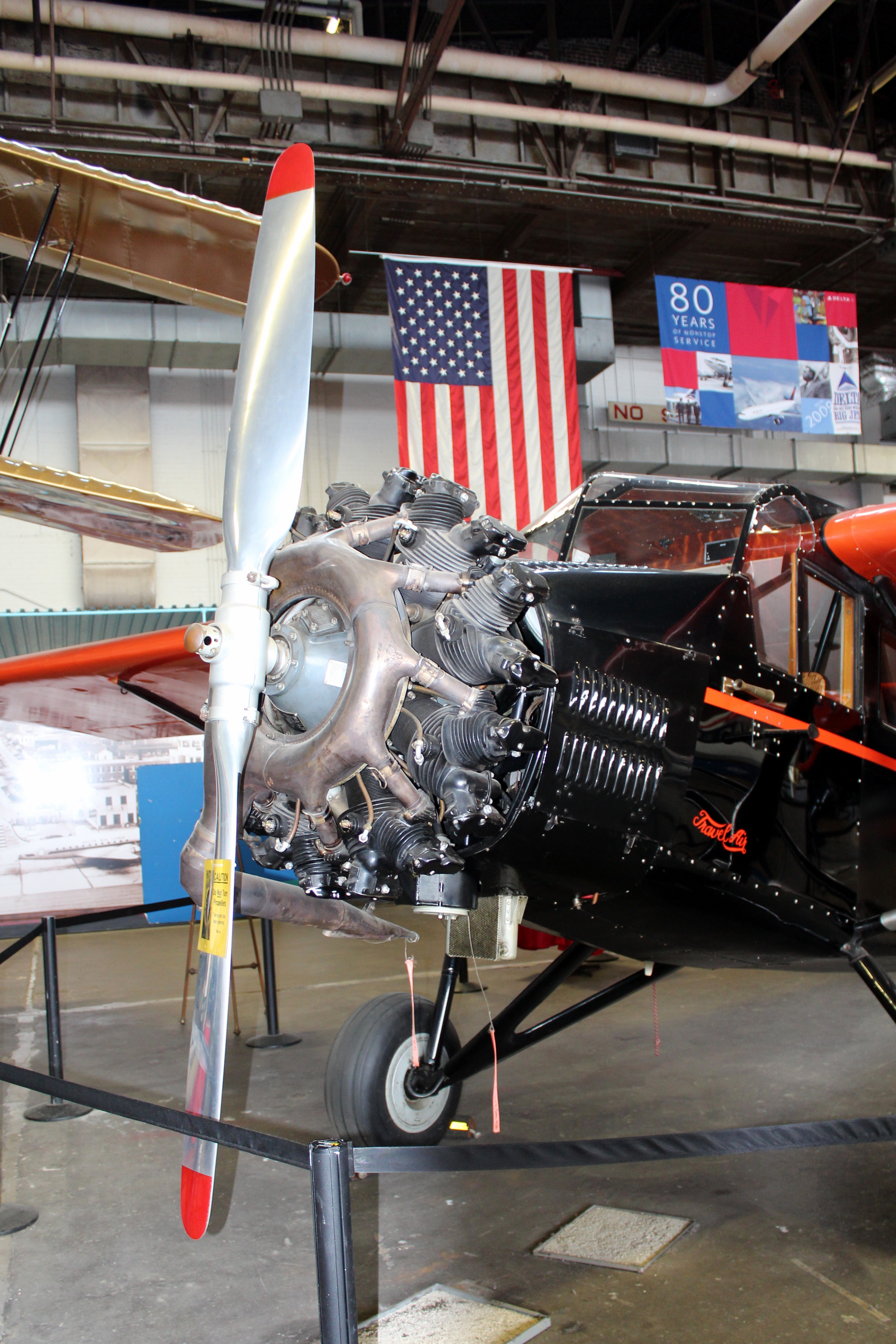 Atlanta - Delta Heritage Museum: 1931 Travel Air 6-B Sedan The 1931 Travel Air 6-B Sedan, housed in Hangar 1 of the Delta Heritage Museum, represents Delta's first passenger aircraft. Delta began flying passengers in a similar plane on June 17, 1929. The 427-mile flight from Dallas, Texas to Jackson, Mississippi, with stops in Monroe and Shreveport, Louisiana, took five hours and costs $47.25 one-way. The Travel Air 6000 seats 5 passengers, a pilot, and a co-pilot in lightweight wicker seats. It cruises at 95 miles per hour and has a maximum range of 550 miles. The Delta Heritage Museum, an aviation and corporate museum housed in two 1940's era Delta Air Lines maintenances hangars outside Atlanta Hartsfield International Airport, was established in 1995. The hangars were used until the 1960's when the Delta Technical Operations Center, formerly known as the Jet Base, was completed. The museum's collections and facilities include a number of historical aircrafts including the Spirit of Delta, Delta's first 767, and Ship 41, the first DC-3 to carry Delta passengers, as well as an archives of artifacts related to Delta and its ancestor airlines, an aviation reference library, and a replica of the first Delta station in Monroe, Louisiana.