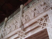 Tomb Canopy, Ewelme Ewelme is distinguished by it's unique surviving complex of medieval buildings, church, almshouses and school, all dating from the 1430s and all still functioning. The benefactors were William and Alice de la Pole, the Duke & Duchess of Suffolk who once had a palace nearby. Alice was also the grand-daughter of Geoffrey Chaucer, and lies buried under one of the finest medieval monuments in England in the church she rebuilt in 1432. The church of St Mary the Virgin in Ewelme is one of the most rewarding parish churches, the star attraction is the Duchess of Suffolk's splendid tomb, erected in 1475, under a canopy south of the altar. She lies in her earthly finery, but below is a memento mori, her cadaver effigy, viewed through openings beneath the row of shield-bearing angels on the tomb chest. The condition of the monument is exceptional, no small thanks to the doors having been locked to 17th century puritan vandals. There are other fine sculpured details around the church and a magnificent 15th century panelled ceiling to the south chapel, carved with angels. The east window here also contains a medley of 15th century stained glass fragments collected from various windows. Another outstanding feature is the font, also from 1475 which is dominated by it's angel-capped spire-like wooden cover, over 10ft high and raised by a pulley carved like a tudor rose.