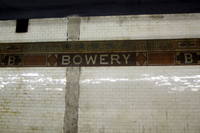 NYC - LES: Bowery Station Bowery, a New York City subway station on the BMT Nassau Street Line located at the intersection of the Bowery and Delancey Street, is served by the J train at all times and the Z train rush hours in the peak direction. Opened on August 4, 1913, it features 4 tracks--2 in revenue service, and 2 island platforms. Bowery, commonly called The Bower is the name of both a street and a small neighborhood. Bowery is an anglicisation of the Dutch bouwerij, derived from an antiquated Dutch word for "farm." In the 17th century the road branched off Broadway north of Fort Amsterdam at the tip of Manhattan to the homestead of Peter Stuyvesant, Director-General of New Netherland. As a street, the Bowery was known as Bowery Lane prior to 1807. Today it runs from Chatham Square in the south to Cooper Square at 4th Street in the north.