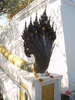 Sinister Nagas, Wat Phra Phutthabat Wat Phra Phutthabat is located some distance south of the city of Lop Buri, and is a beautiful temple built in the 17th century to enshrine the site of one of the Lord Buddha's footprints (identified in a roughly foot-shaped pool by a white stag whose statue stands nearby). The 'footprint' itself is now a large gilded cavity beneath a rich shrine in the most stunning building on the site, the gloriously gilded main shrine, crowned by a spire and very similar to the phra mondop at Wat Phra Kaew in Bangkok. The whole temple complex is a delight to explore and features numerous lesser shrines and some rather fearsome looking Nagas! en.wikipedia.org/wiki/Phra_Phutthabat_District